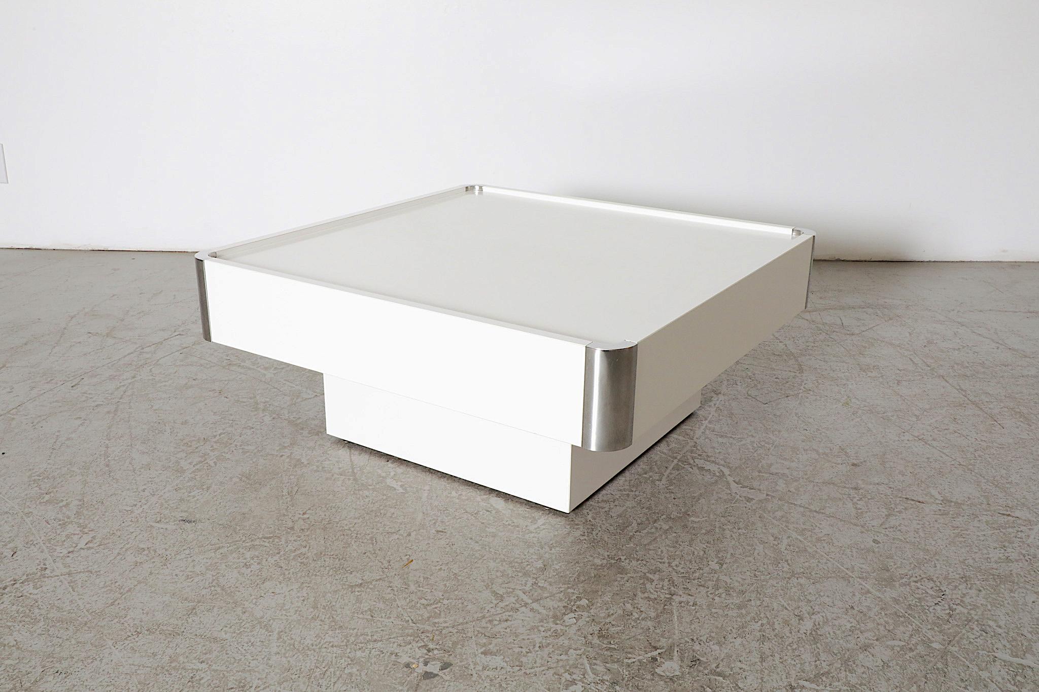 Modernist 1970's white coffee table with chrome corners design by famed Italian designer Willy Rizzo. Made for the Mario Sabot label. Pure and clean example of Italian minimalistic design. In original condition with visible wear including light