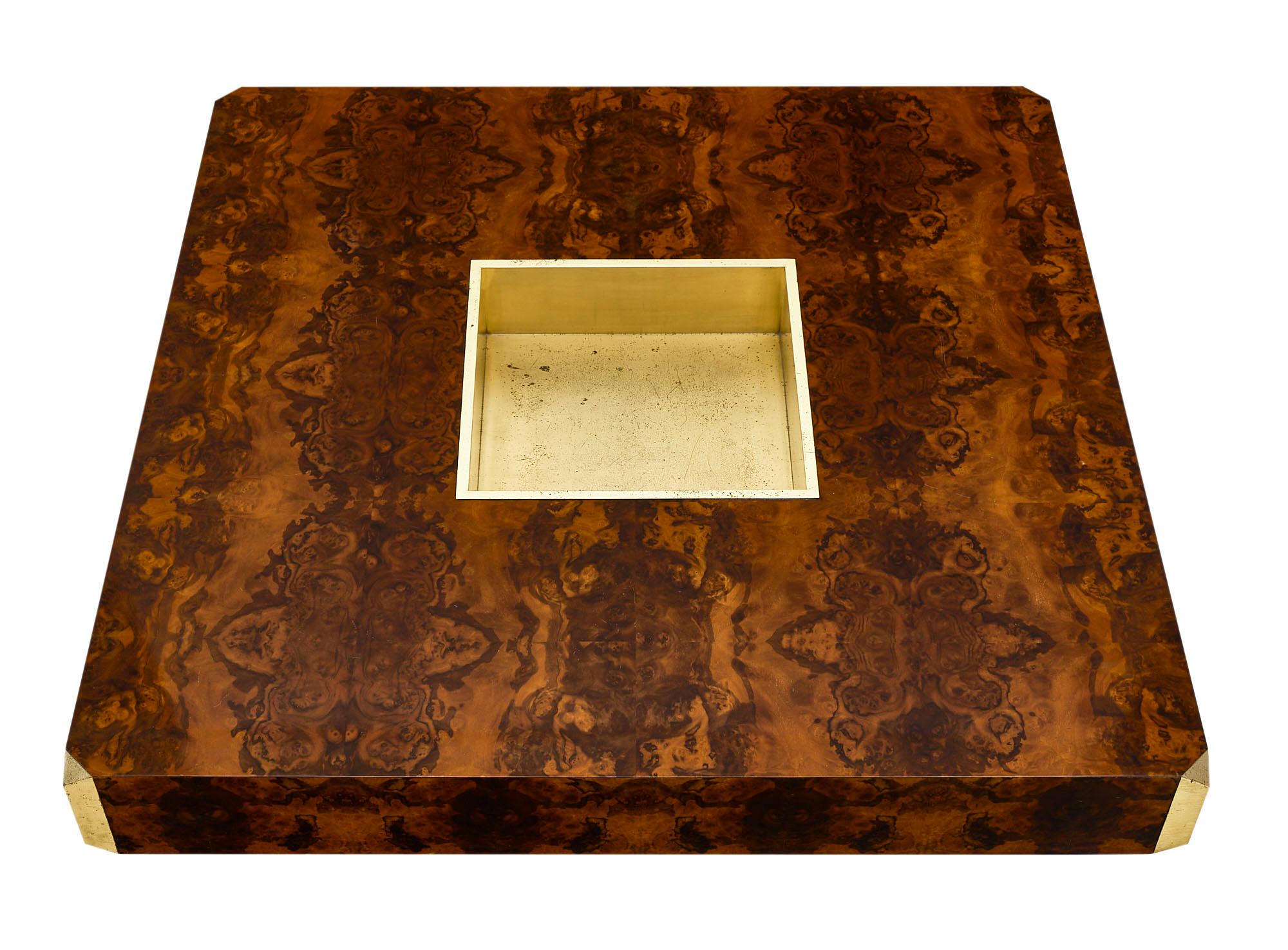 Square Willy Rizzo coffee table with burled walnut veneer and a lustrous French polish finish. The central brass compartment was designed originally to hold bottles. The table is adorned with brass corners as well. This piece is in excellent