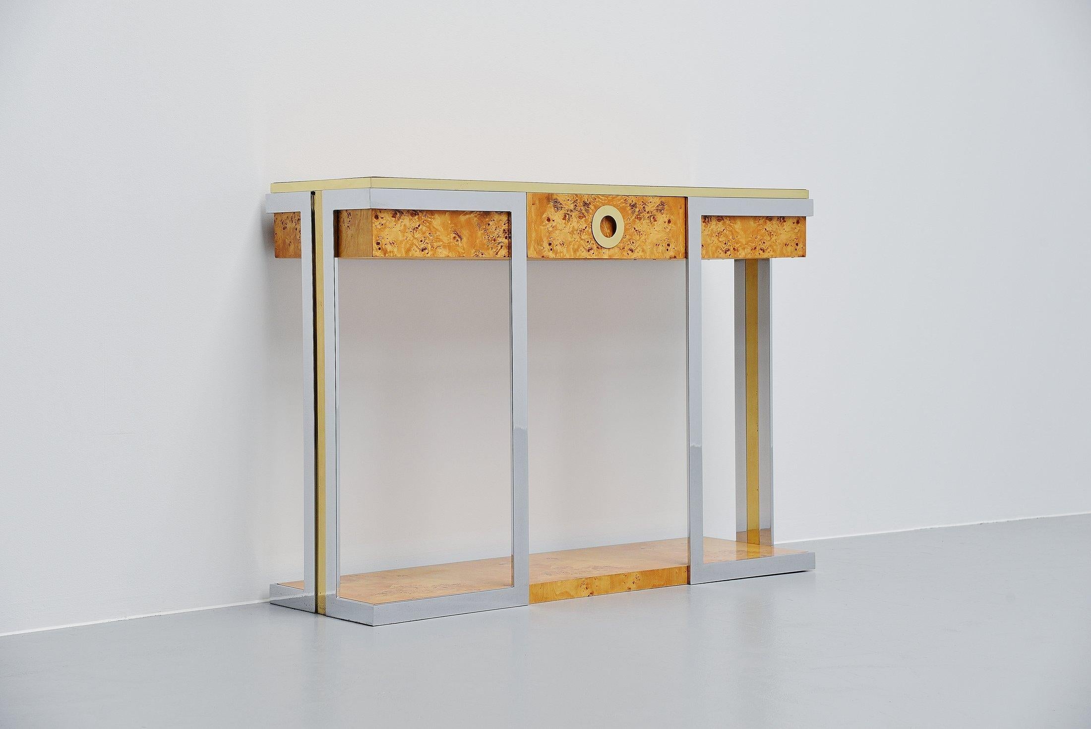 Very nice Hollywood Regency style console table designed by Willy Rizzo and manufactured by Mario Sabot, Italy 1970. The console is made of burl wood veneer and has brass and chrome details. It has a drawer in the middle, for small storage space.