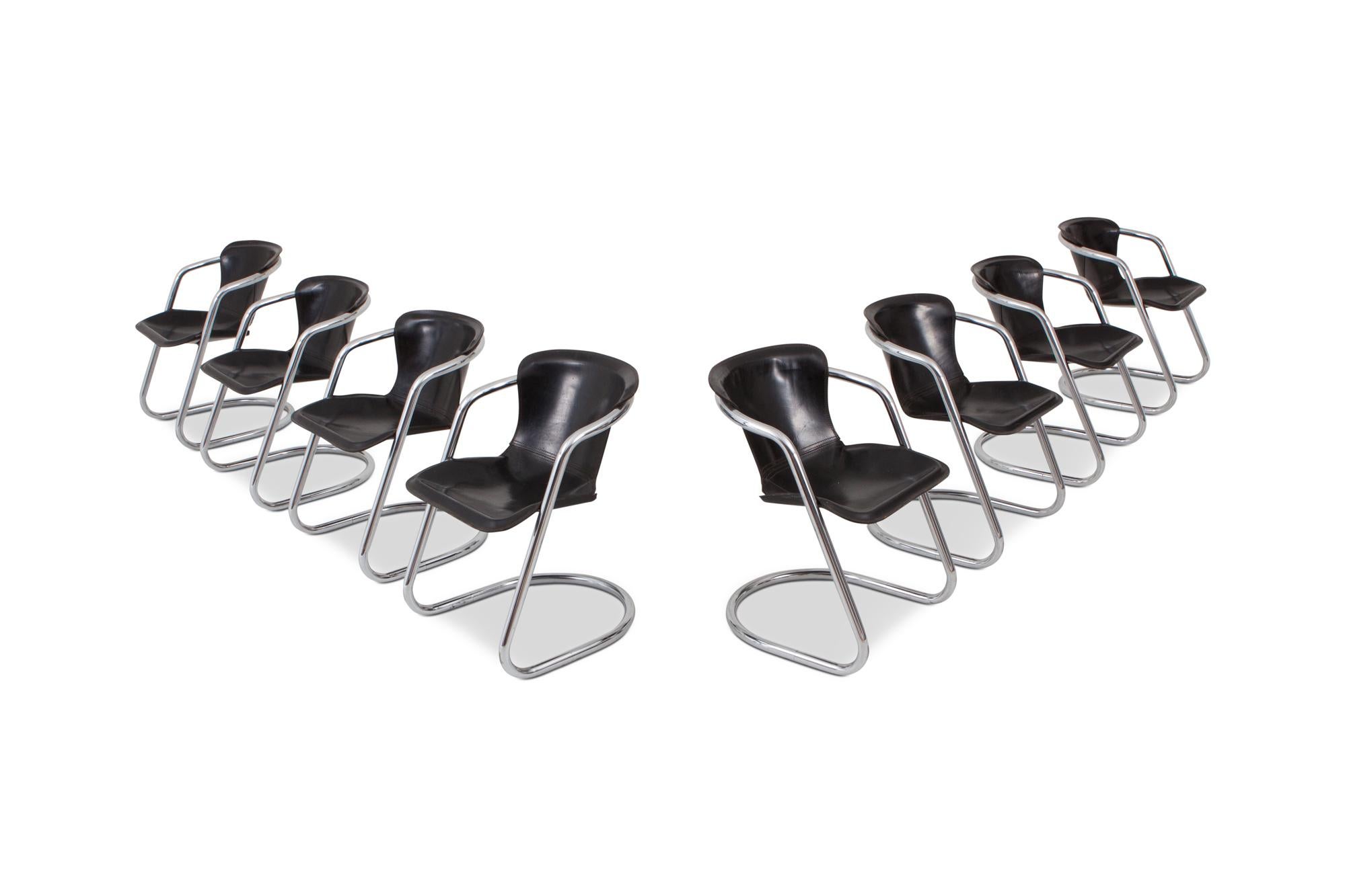Mid-century modern tubular chrome dining chairs by Willy Rizzo, produced by Cidue, Italy, 1970s.

The chrome tubular frame holds thick black saddle leather seats which are in great condition and starting to show a lovely patina which will age even