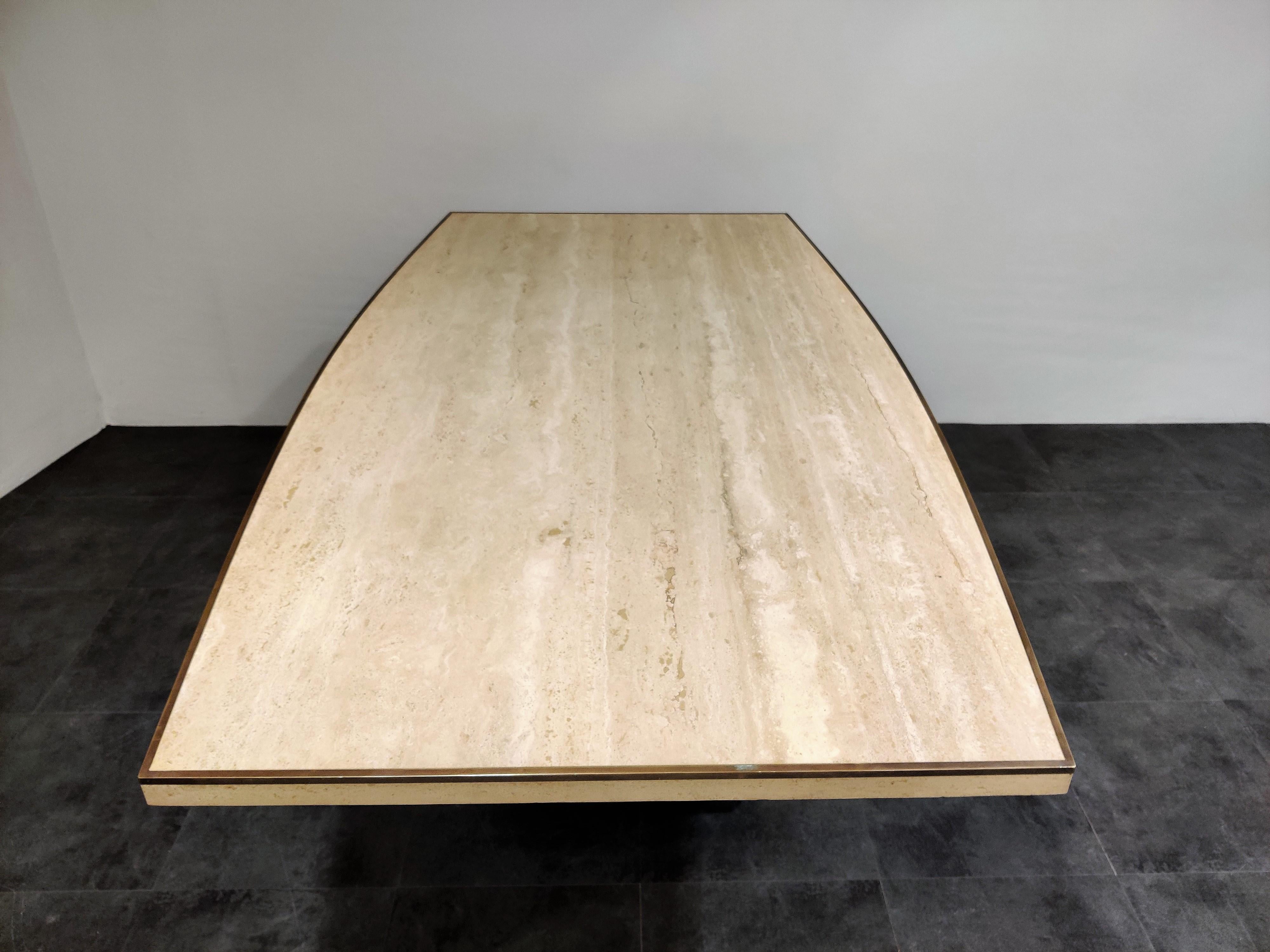 Dining table by Willy Rizzo for Jean Charles, France, 1970s. 

High quality piece out of travertine and nice solid brass details like the edges around the top and the base. The table has a beautiful curved form and has the right patina.

1970s,