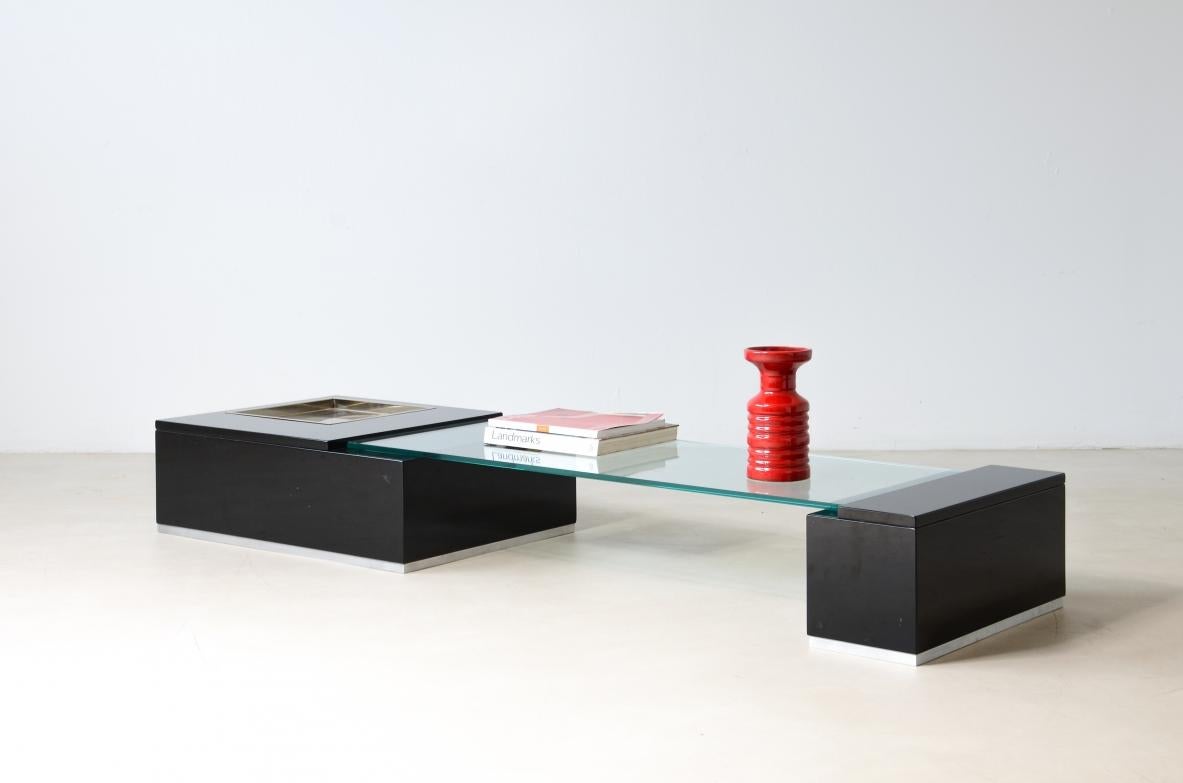 
COD-2762
Willy Rizzo (1928-2013)

Extraordinary low table composed of two lacquered wooden bodies with a thick cut glass top, steel tub for objects.

Manufactured by Rizzo & Co, Rome/Paris, ca.1970.

180x50xh25