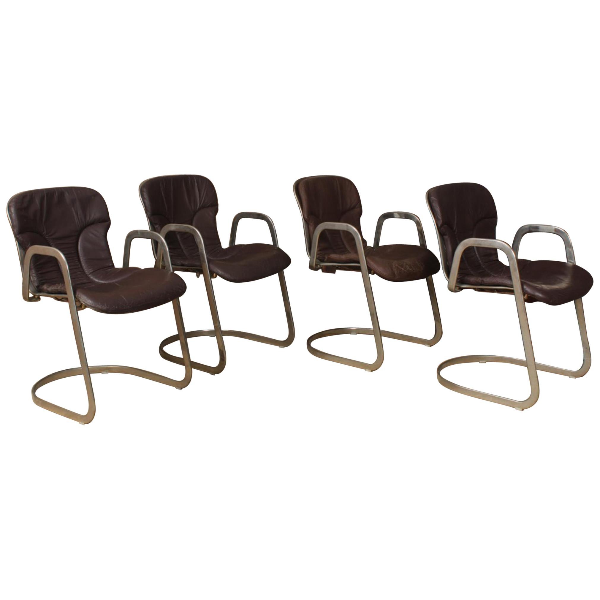 Willy Rizzo for Cidue Italia Postmodern chrome and leather dining side armchairs. Rare midcentury sculptural stainless steel cantilever armchairs with original leather cushions. Labeled. Listing is for set of four.