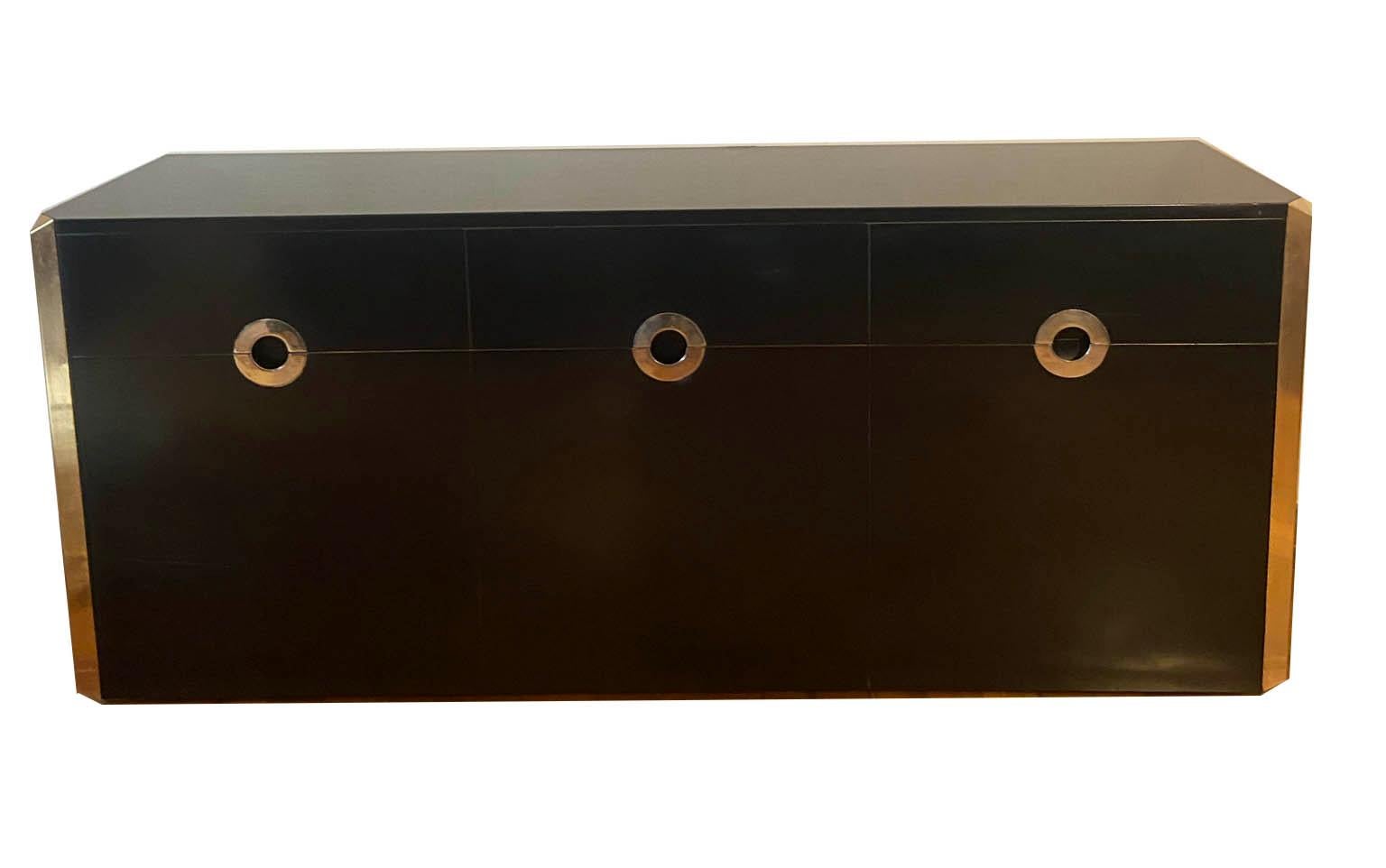 Sideboard in satin black lacquered wood with brass profiles and chromed metal handles by Willy Rizzo for Mario Sabot, Italy, 1972. An iconic piece by Willy Rizzo in excellent condition. It has two opening side doors, one centre drop-down door and