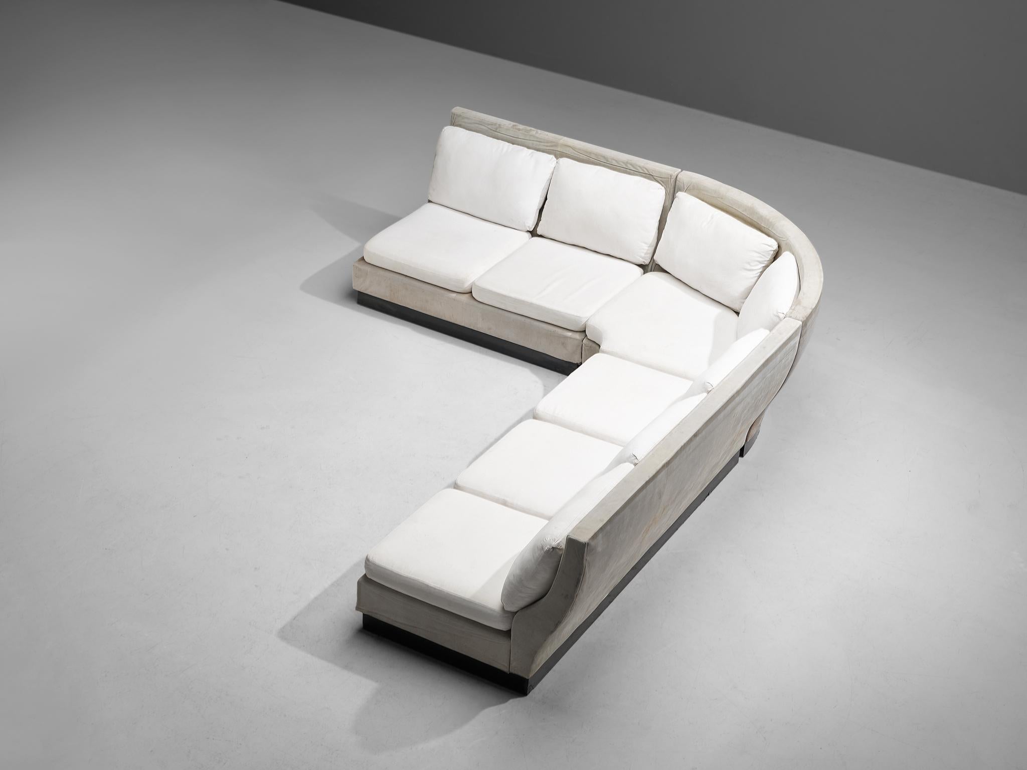 Willy Rizzo for Mario Sabot, sectional corner sofa, fabric, ultrasuede, wood, Italy, 1970s.

This rare sofa is designed by Willy Rizzo and consists of a three-seater, two-seater, and corner element. The cushions are upholstered in a white fabric