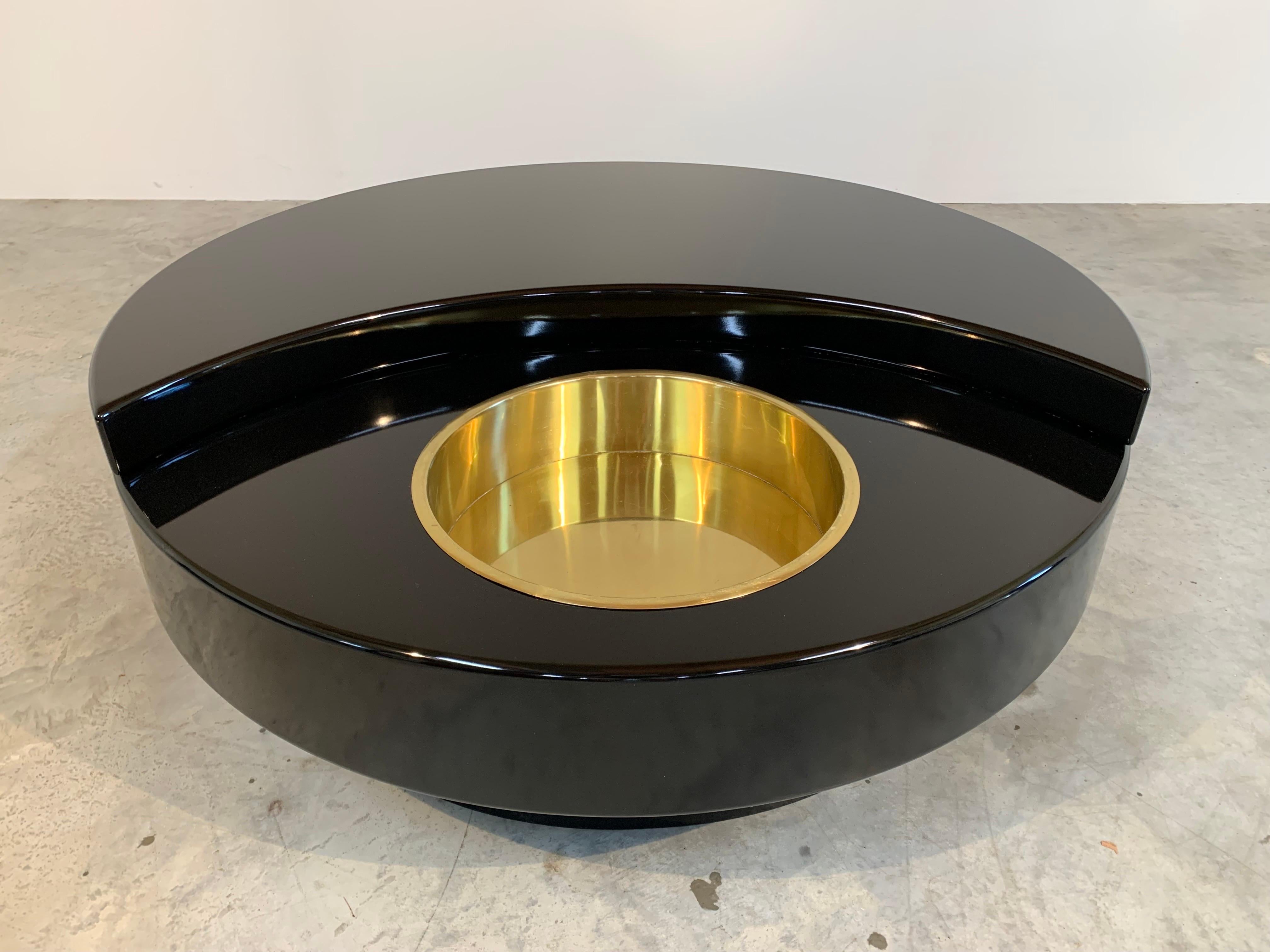 TRG (Tavolo rotondo girevole) round revolving cocktail table designed by Willy Rizzo. Italy, Mario Sabot, ca. 1970. 
Wood construction having black lacquer with robust internal track wheels that spin the top smoothly. Inserted into the first tear