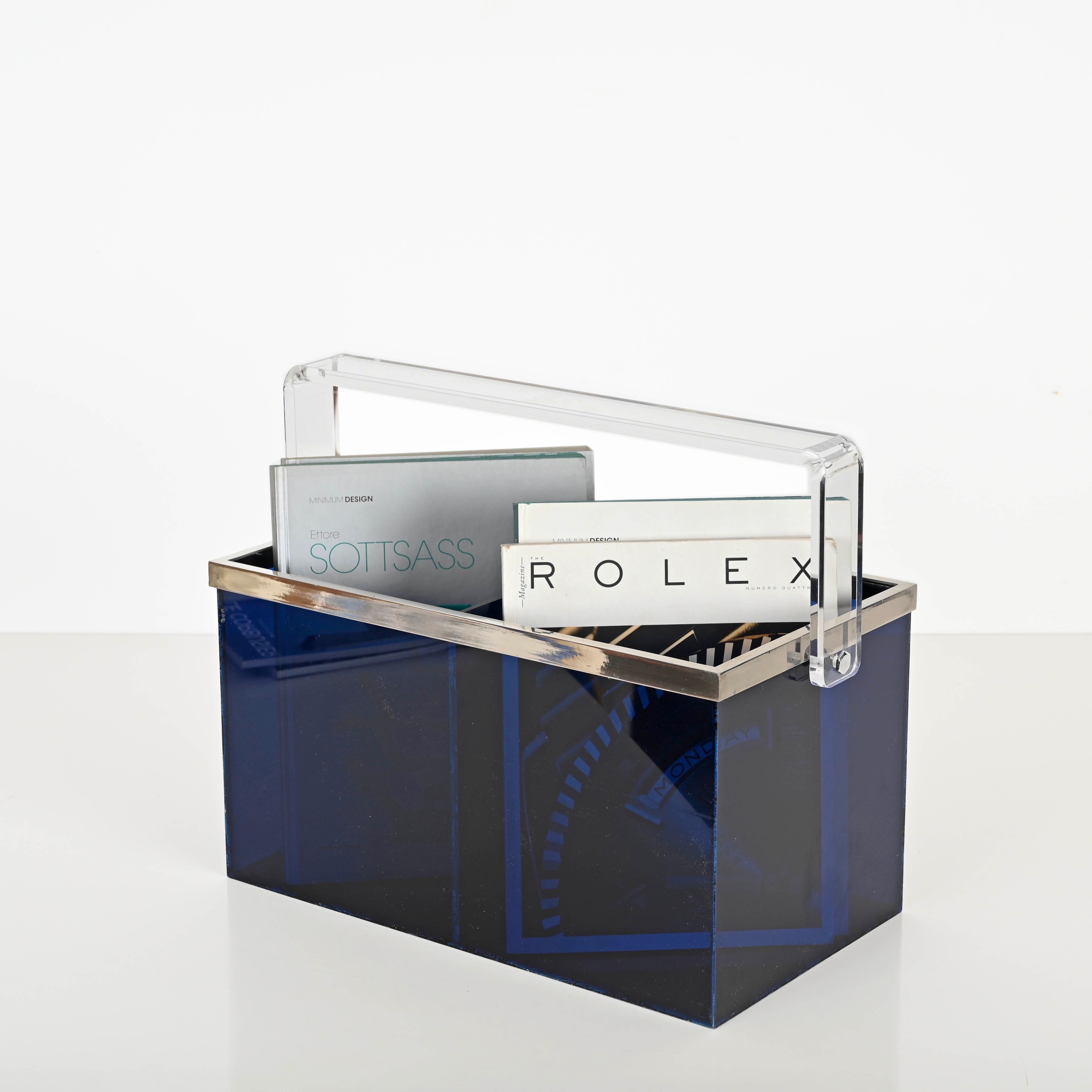 Stunning mid-century magazine rack or bottle holder in blue lucite and chrome. This incredibly charming and unique object was produced in Italy during the 1970s and its design is attributed to Willy Rizzo.

In amazing vintage conditions. This