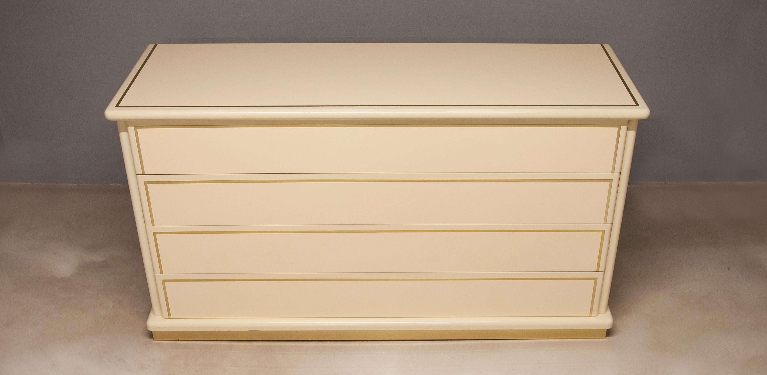 Elegant chest of drawers made by Maria Sabot and attributed to Willy Rizzo, Italy 1970s. Cream white lacquered surface with brass details.