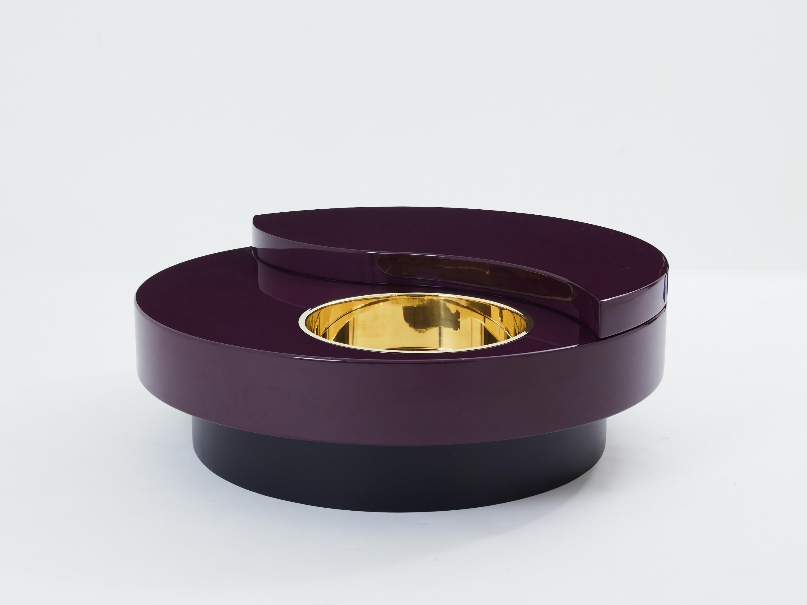 This stunning TRG Yin Yang coffee table is guaranteed to be the focus of attention when you entertain guests in your living room. Following the glamorous mid-century look of other classic Willy Rizzo designs, the crisp eggplant purple lacquered top