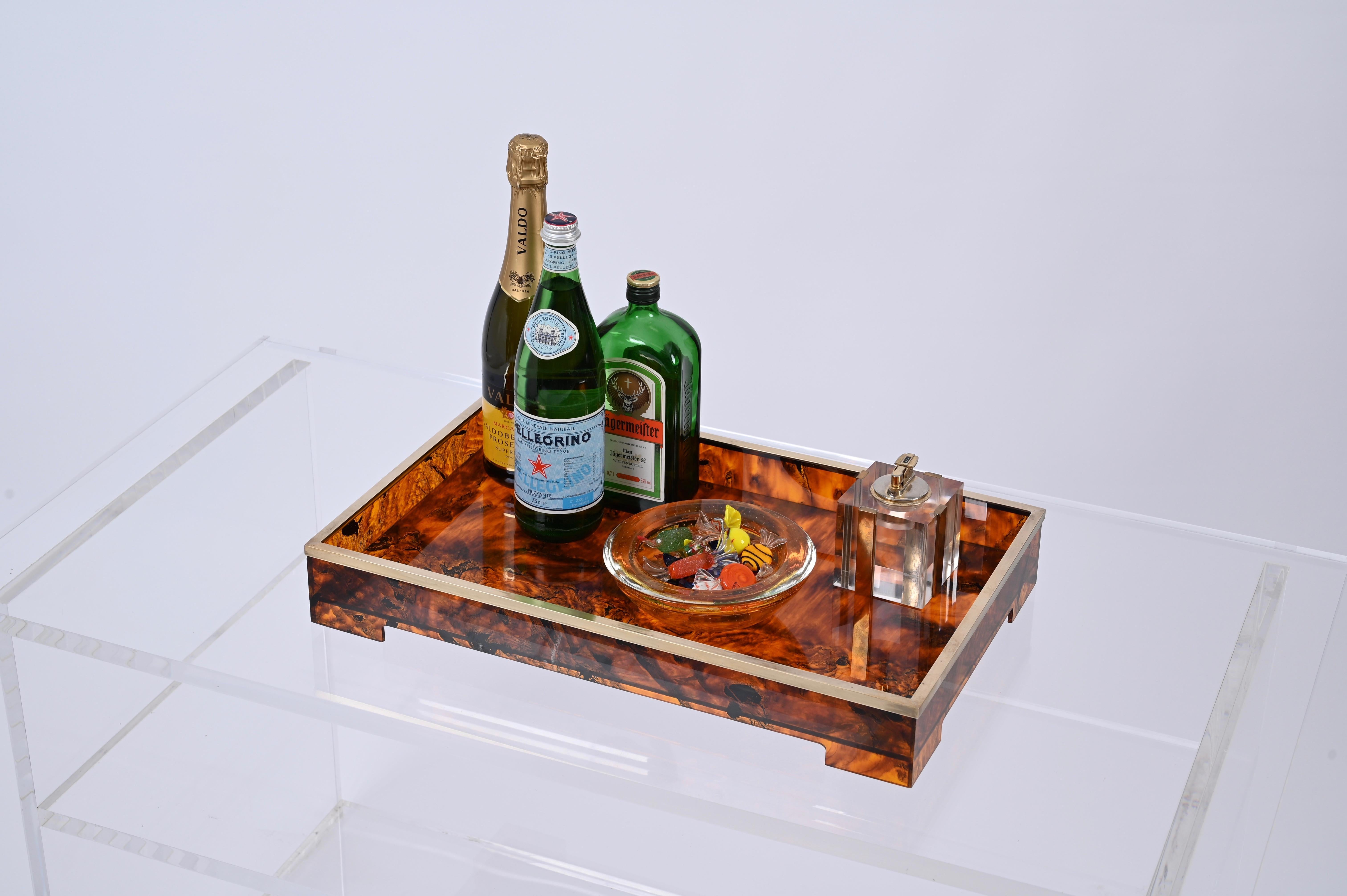 Astonishing large mid-century tray in tortoiseshell lucite and brass. This incredible piece was produced in Italy during the 1970s and its design is attributed to Willy Rizzo.

A real iconic tortoise and Lucite serving tray with the characteristics