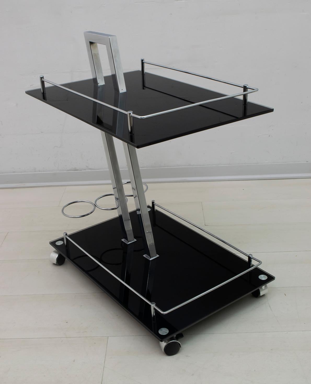 High-end modernist bar trolley made with sturdy chrome frame and black tempered glass, attributed to Willy Rizzo.