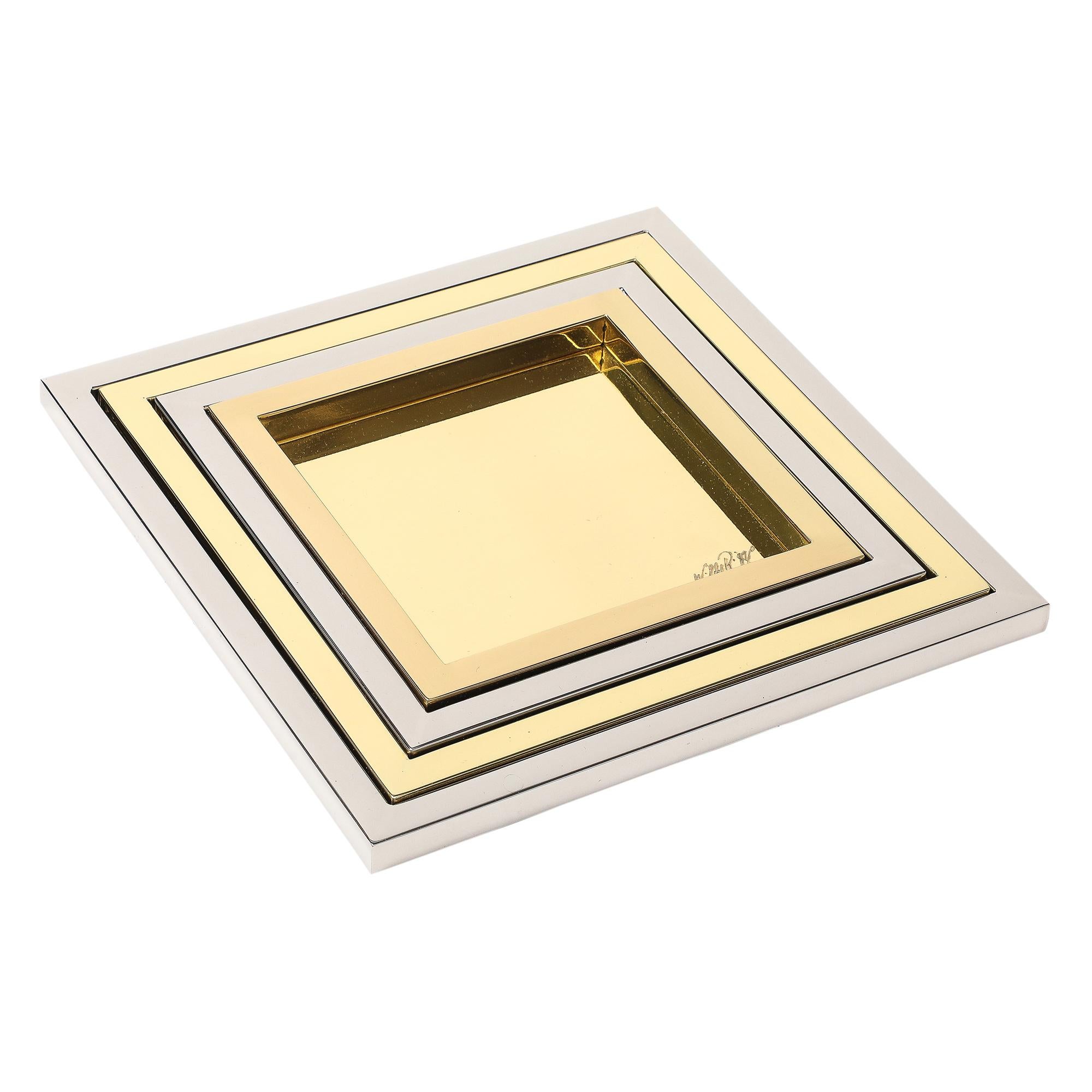 Willy Rizzo nesting trays brass, stainless steel, signed. Chic set of 4 square nesting trays finished in polished stainless steel and brass. Handcrafted in Italy by Studio Willy Rizzo. The graduated trays measure: 6.5 inches, 8 inches, 9.5 inches