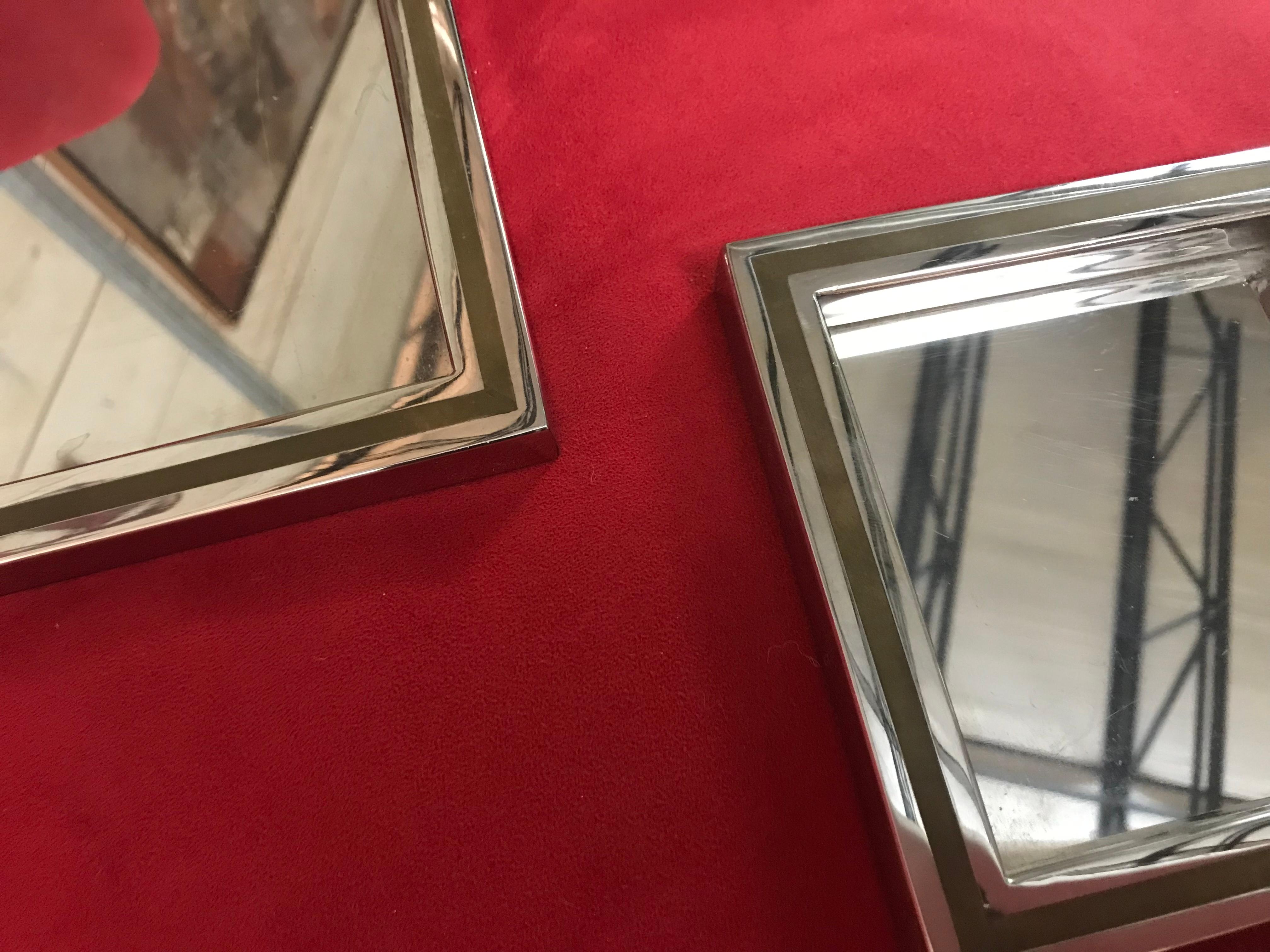 This set of polished steel with brass nesting trays are signed by the artist. They are in good condition with nice patina to the brass.