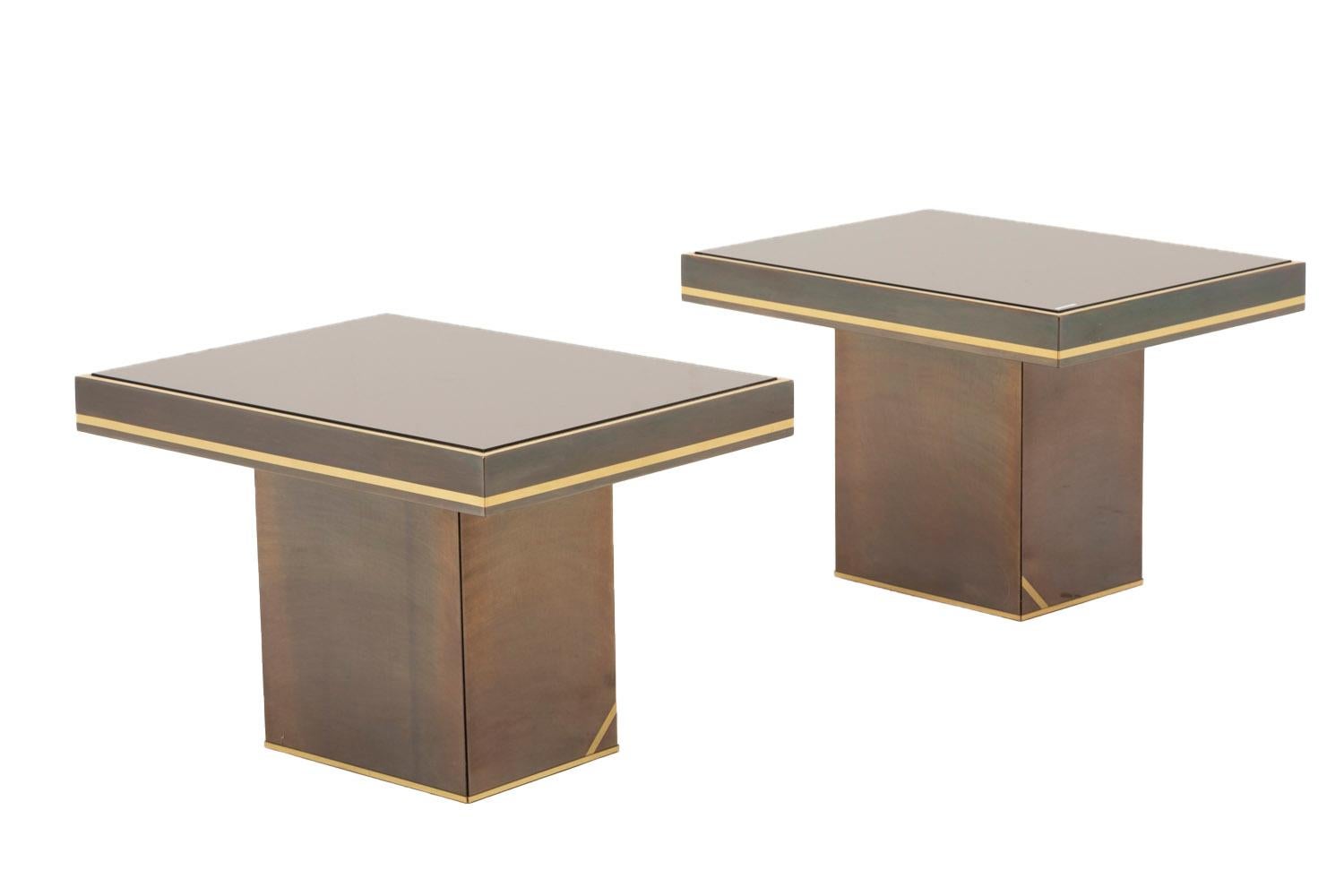 Willy Rizzo, in the style of.

Pair of rectangular end tables in coppered mirrors standing on a cubic smaller brass in covered of brushed coppered metal. 
Lower part of the stand and the tray, also the tray’s frame are adorned with gilt brass.