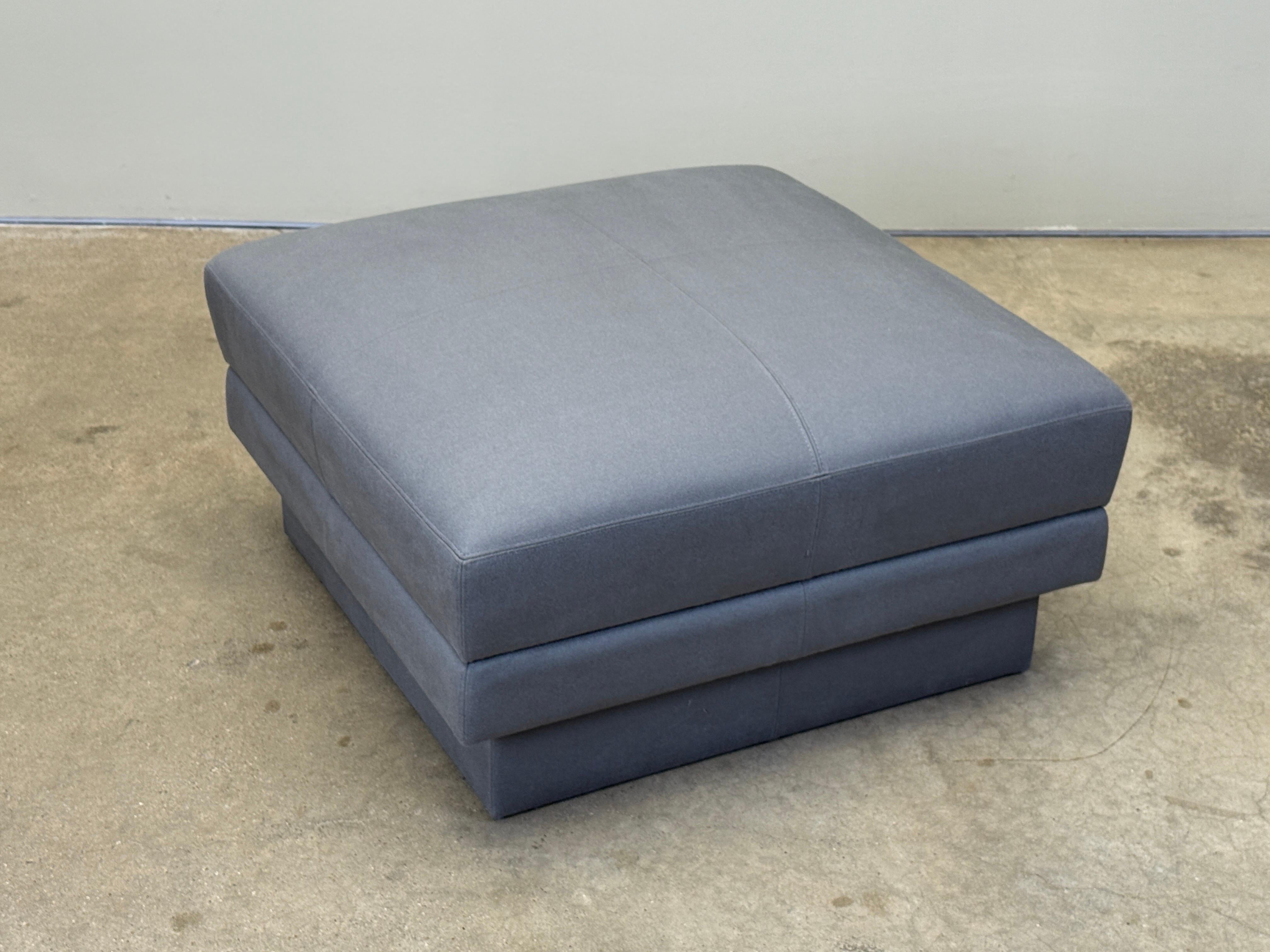 A beautifully tailored Willy Rizzo rolling ottoman with hidden casters.  