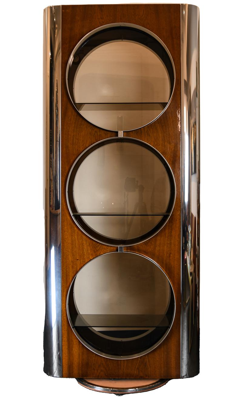 Very rare Willy Rizzo designed display case from the 1970's. This stunning display with its porthole windows is crafted from laminated wood and mirror polished stainless steel. The display rotates 360 degrees on a circular base covered in eco-suede