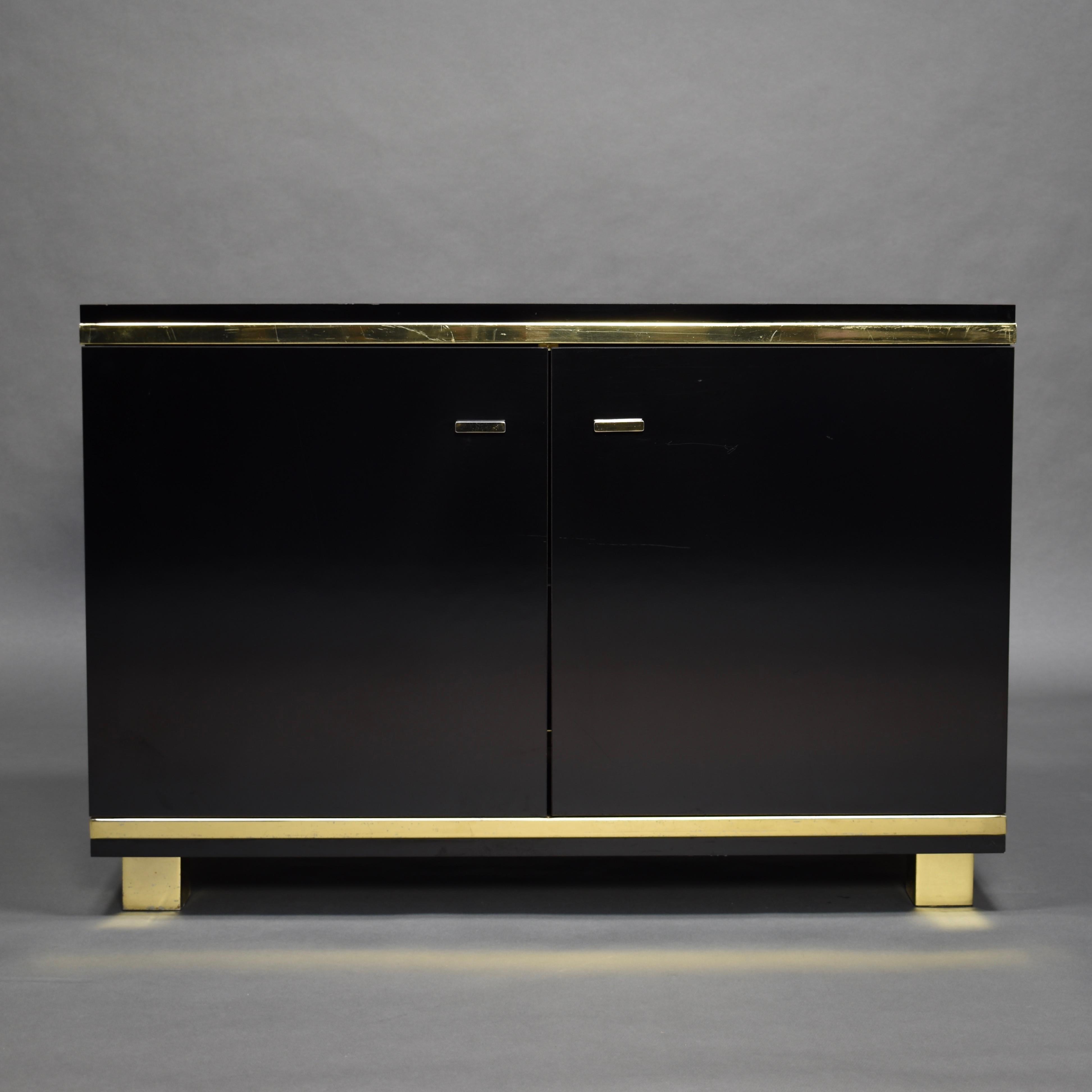 Willy Rizzo style credenza in black melamine and brass details, circa 1970.

Designer: in the style of Willy Rizzo

Manufacturer: Unknown

Country: Italy

Model: credenza / sideboard

Material: melamine, brass

Period: circa 1970

Size