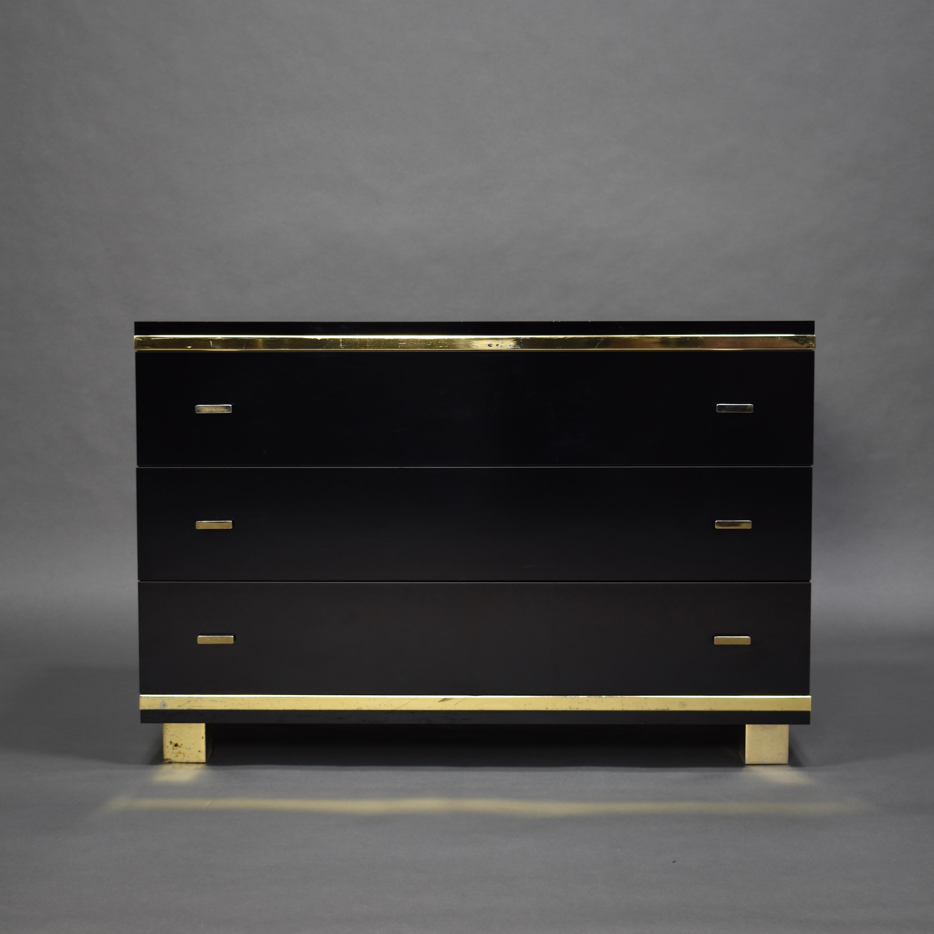 Italian drawer in black melamine and brass details, circa 1970.

Designer: in the style of Willy Rizzo

Manufacturer: Unknown

Country: Italy

Model: Credenza / sideboard

Material: Melamine, brass

Period: circa 1970

Size wdh: 90 x