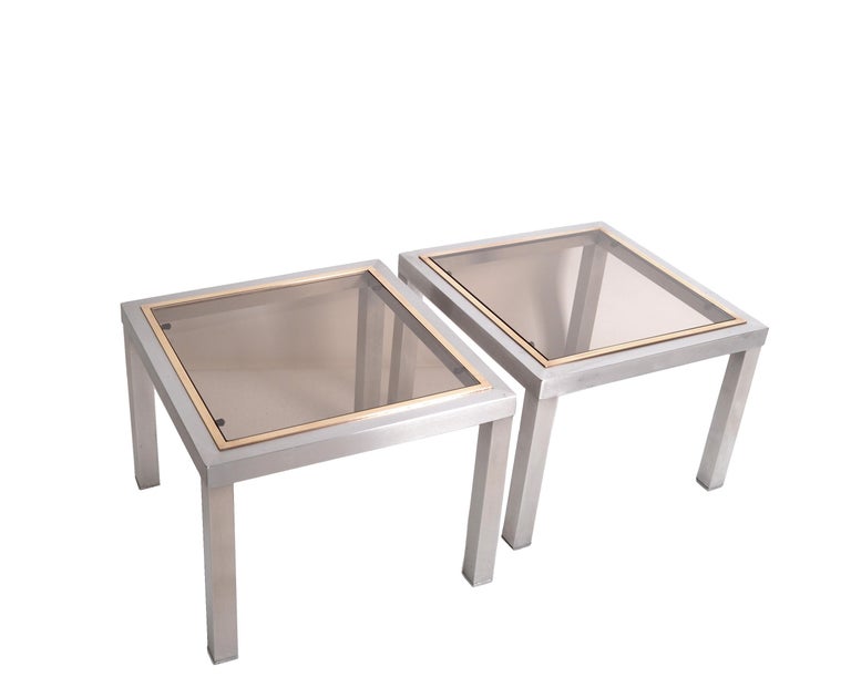 Two French Mid-Century Modern square side tables Willy Rizzo style.
Chrome bases with top brass frame and smoked glass which rests on rubber protections.
It is a set as there is 1 inch height difference.
Great for display your favorite sculptures