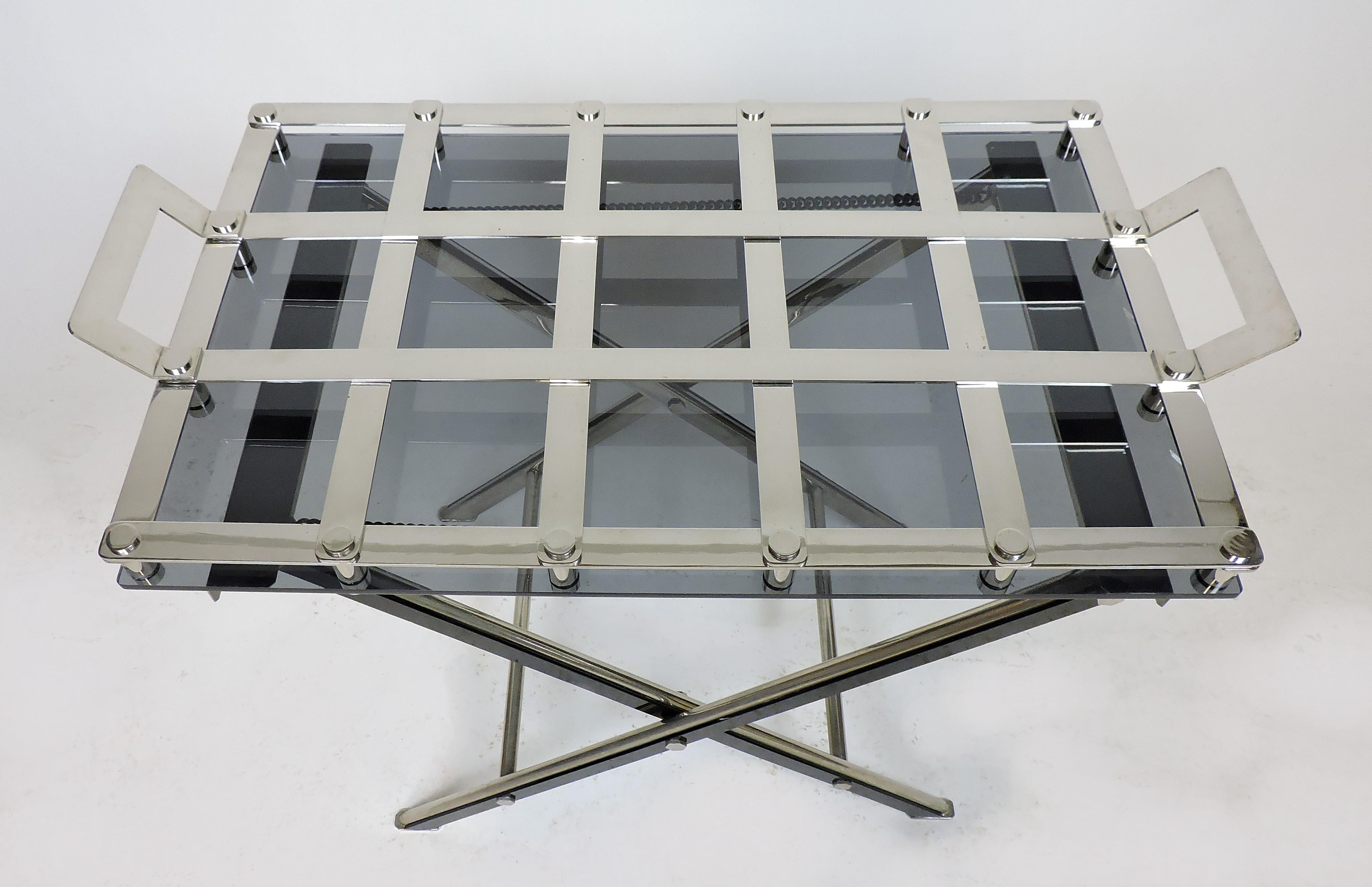 Handsome Willy Rizzo style butlers tray with stand, made of chrome-plated steel. The tray has a a gray Lucite bottom and the stand has black Lucite accents. The tray has two handles and grid openings to place glasses, and the stand can be folded.
 
