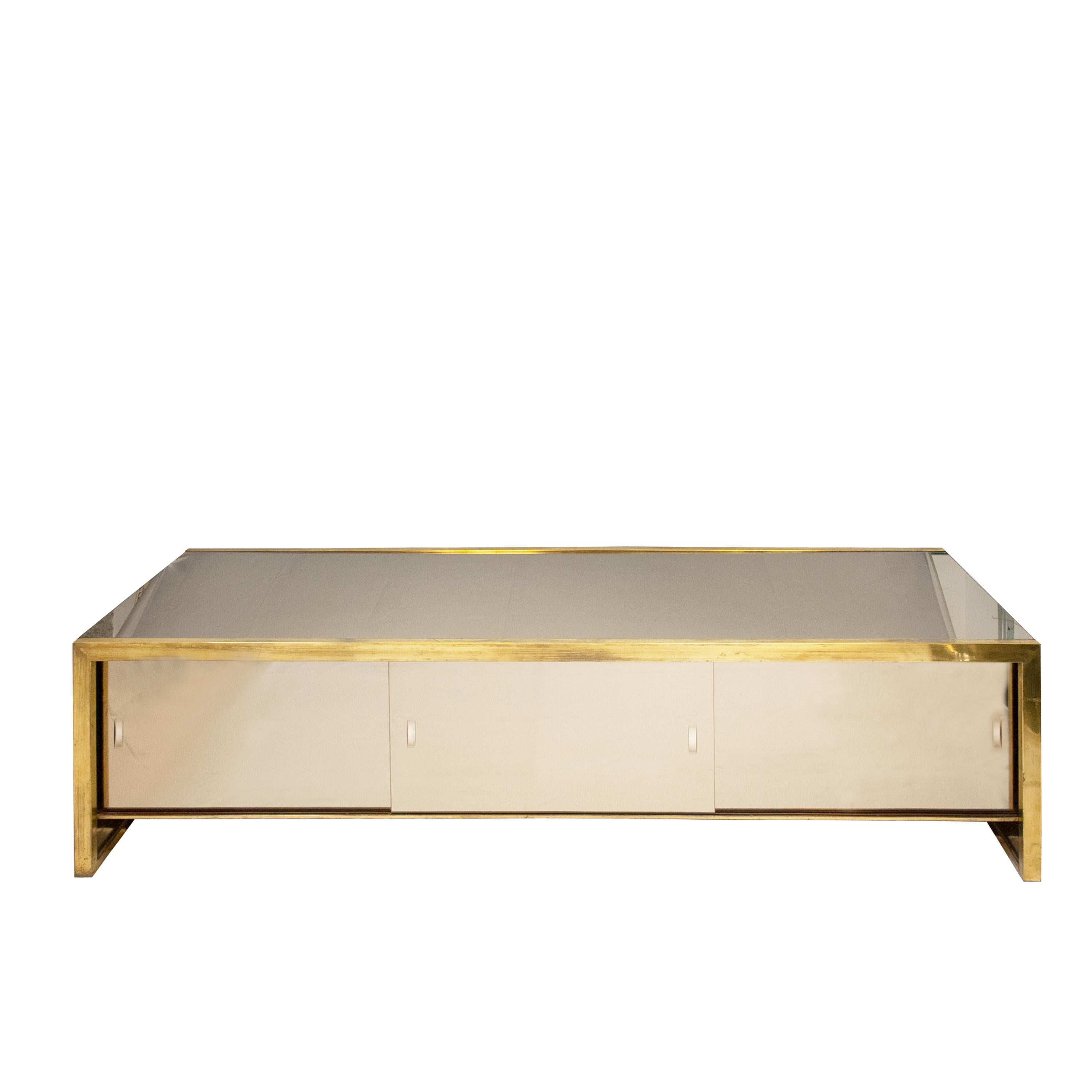 An Italian three-door mirrored sideboard from the 1970s, In the style of Willy Rizzo.
The sideboard is made of a birch wood structure, covered with a mirror surface and a brass framework.
It contained two wooden drawers and vertical and horizontal