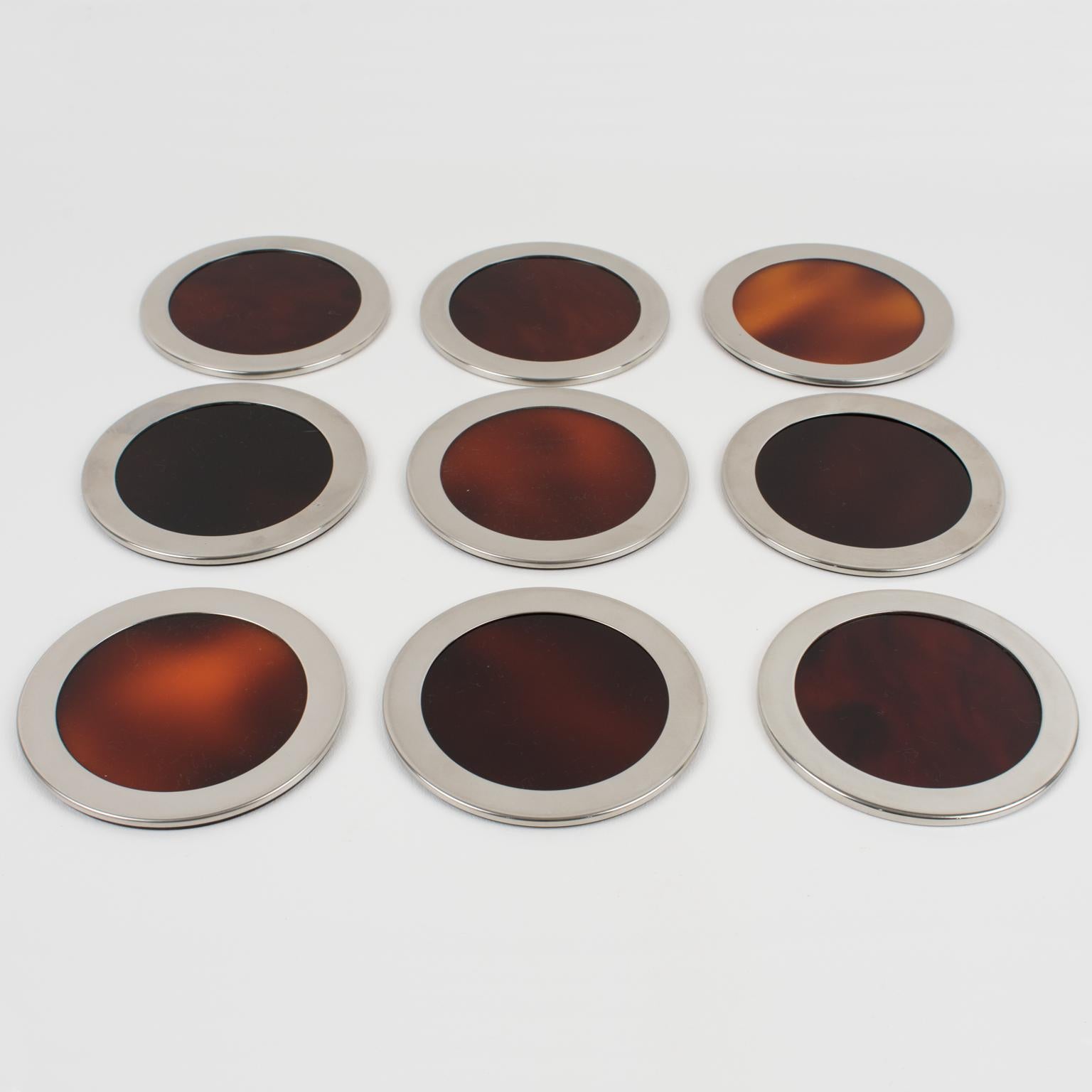 Lovely 1970s modernist barware set of nine coasters, design attributed to Willy Rizzo. Rounded shape with tortoiseshell (tortoise) translucent Lucite and chromed metal framing.
Measurements: 4.32 in. diameter (11 cm) x 0.19 in. high (0.5