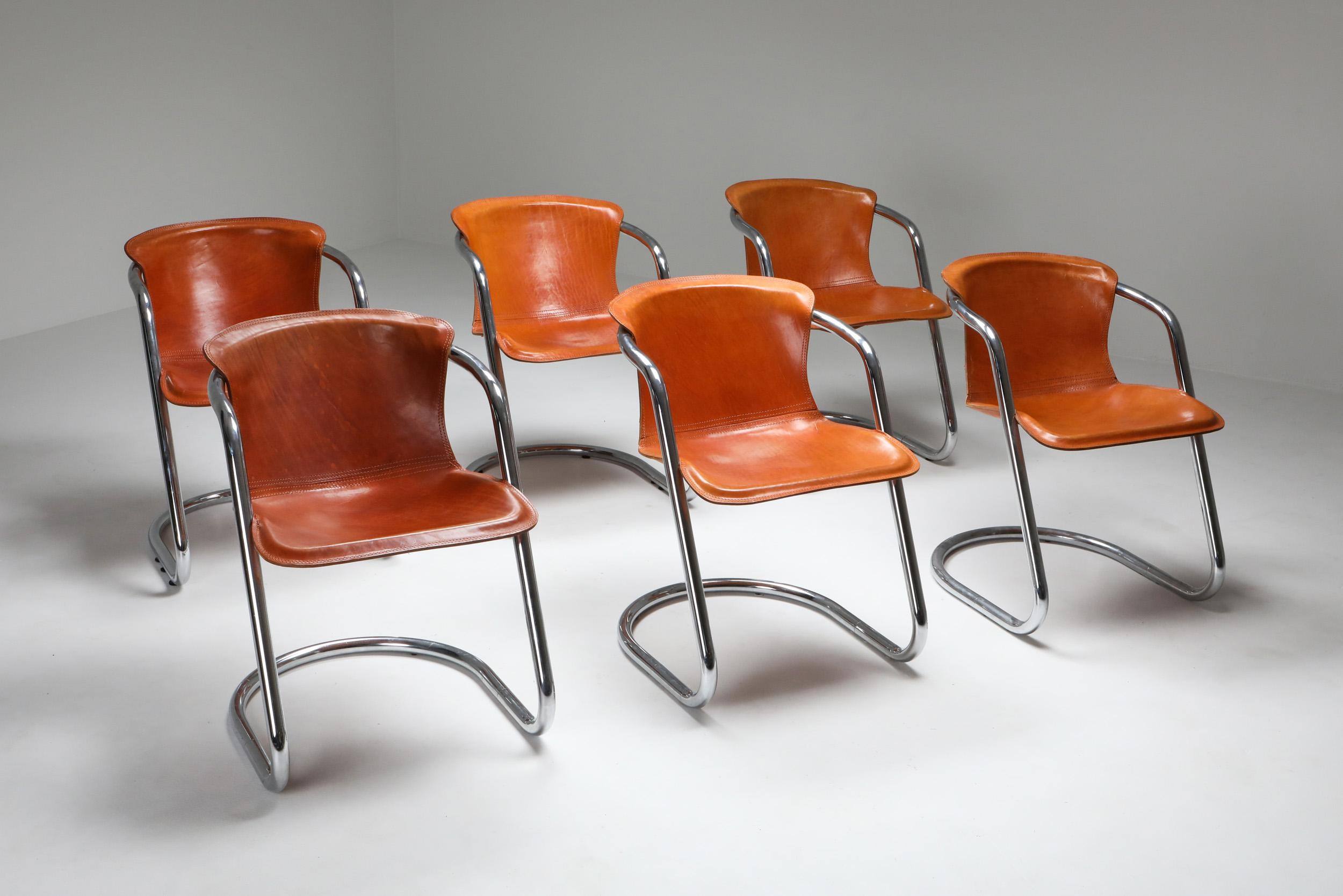Cognac saddle leather dining chairs, set of six, Willy Rizzo, Cidue, Italy, 1970s

Superb set of armchairs by Willy Rizzo, a famous fashion photographer who became a furniture designer best known for it's Italian glam style.
The tubular chrome