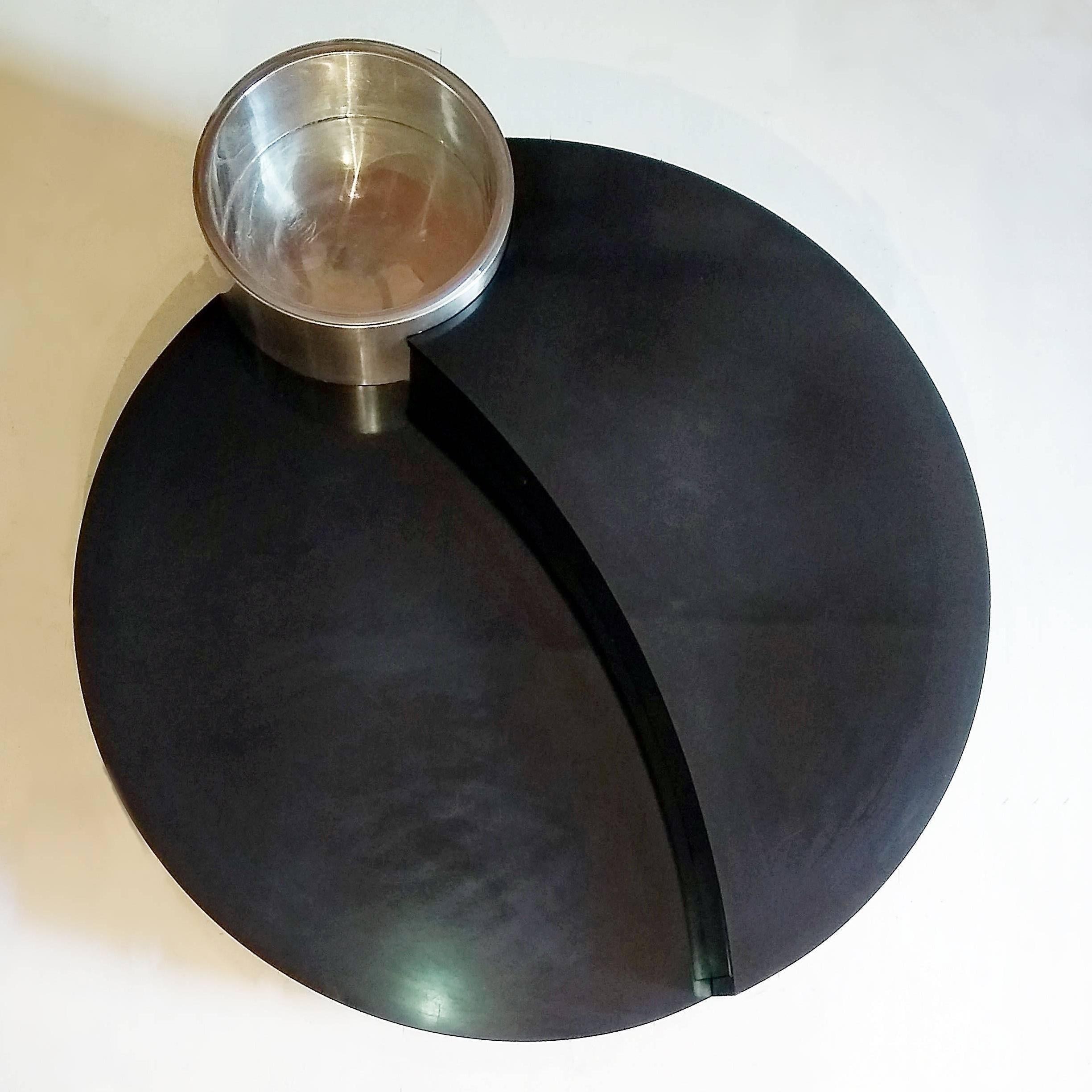 Round coffee table by Willy Rizzo in 1970. The table is in black lacquered, aluminium and chrome.

Willy Rizzo (1928-2013) from Naples, Italy is a photograph and designer. He began with photography and he enters into the world of the cinema.