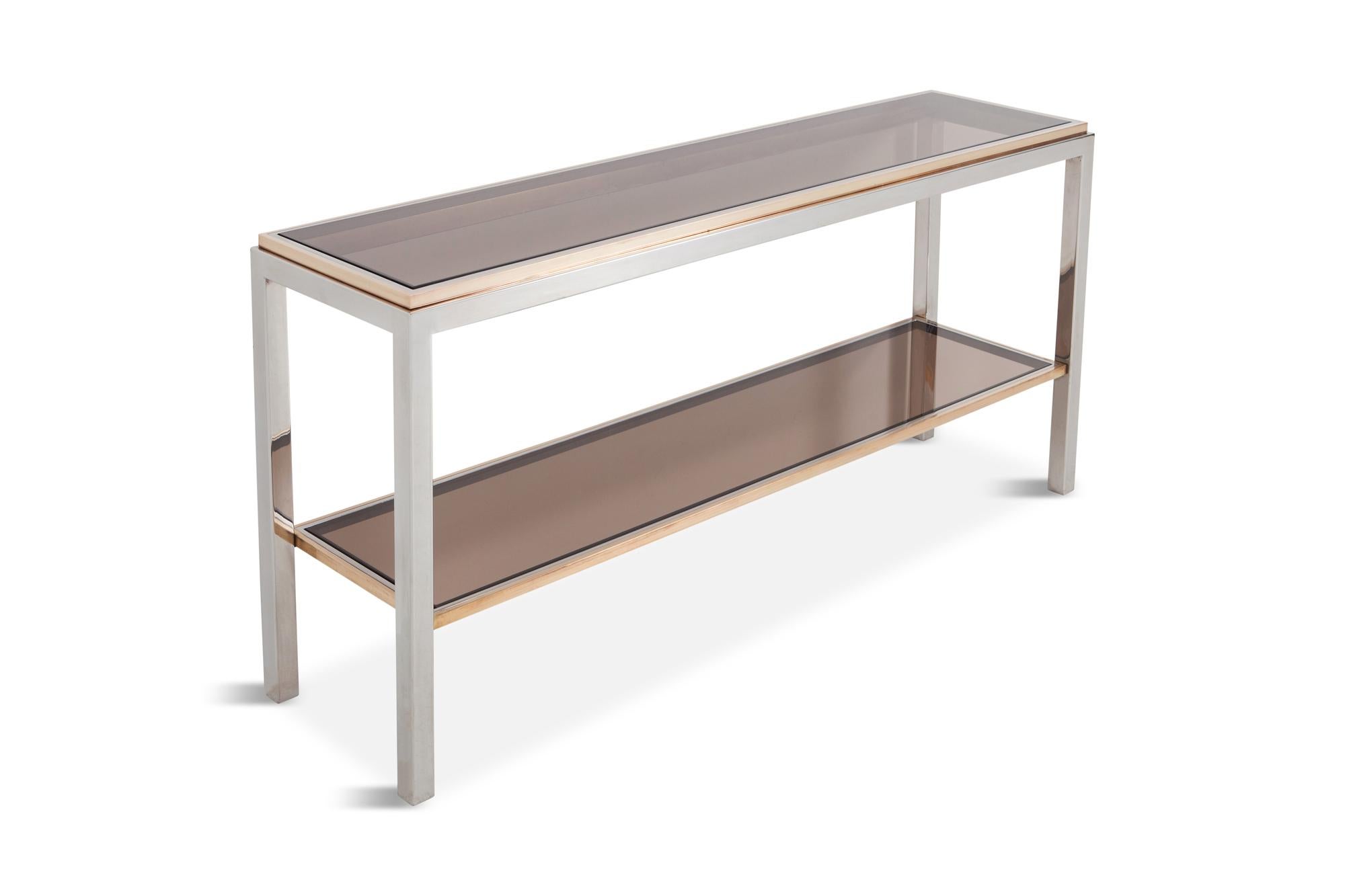 Exceptionally large console table by Willy Rizzo from his Linea Flaminia collection
a two-tier console table in chromed metal with solid brass details and smoked glass shelves.
Would fit well in a Hollywood Regency inspired glam interior, although