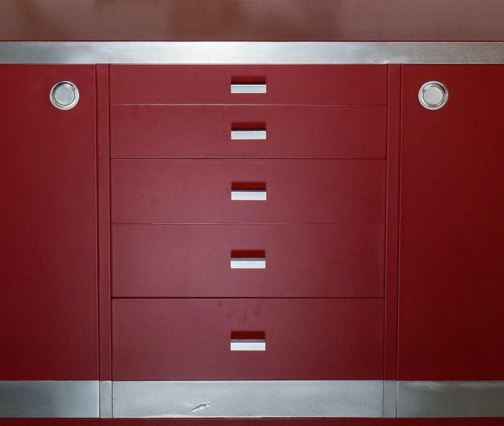 Willy Rizzo sideboard is a midcentury design living room set realized by by Willy Rizzo for Mario Sabot in 1970s.

Structure is composed by solid wood laquered and veneered by red laminate. 

Metal chrome plating for handles and corners.