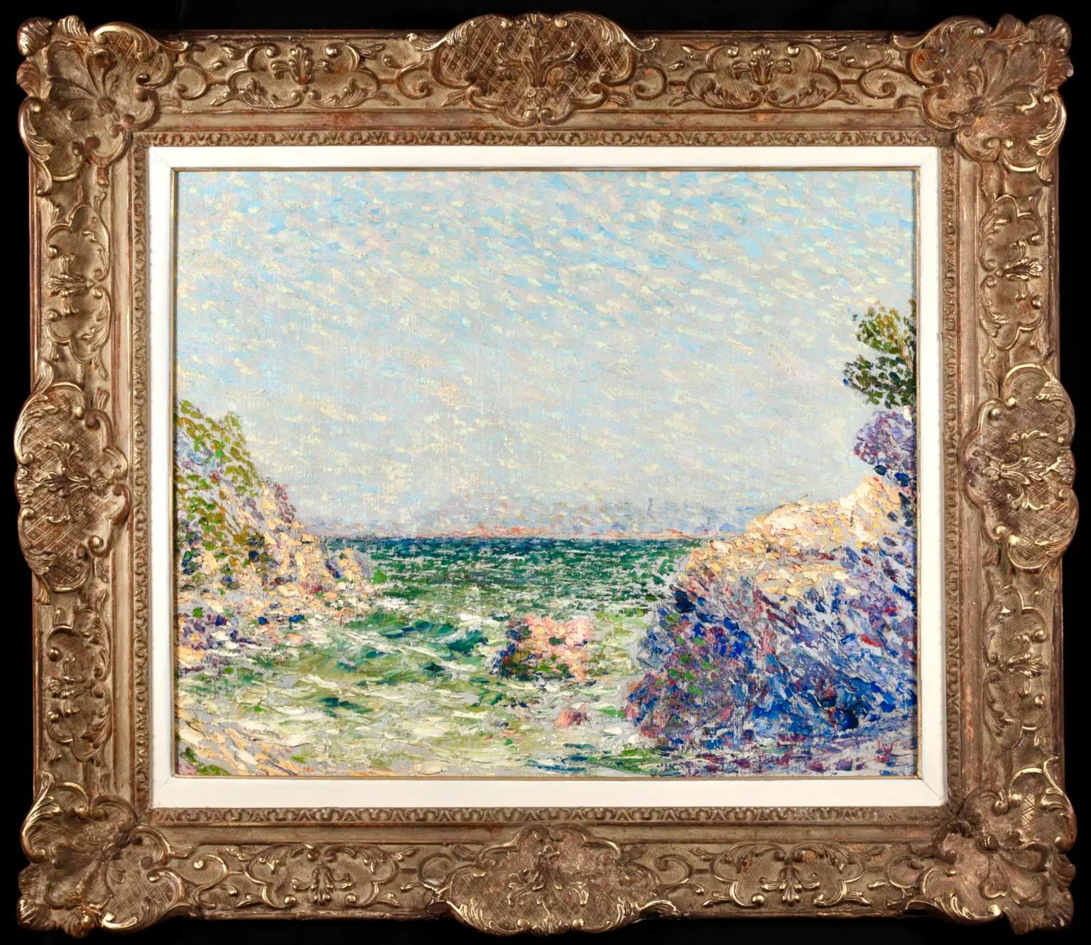 Signed and dated pointillist landscape oil on canvas by Belgian impressionist painter Willy Schlobach. The piece depicts a coastal view looking out over the dark green sea to where it meets the powder blue sky on the distant horizon, with rock