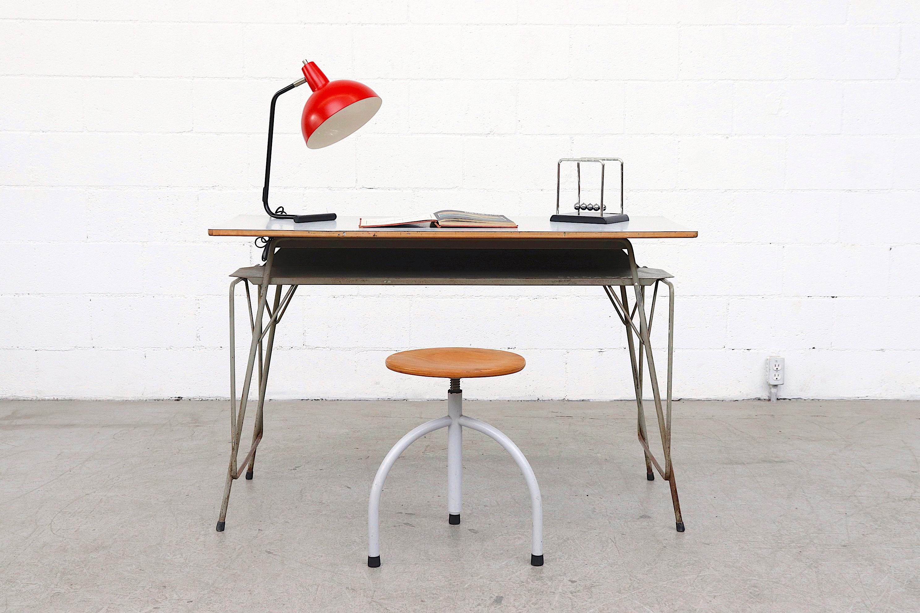 Midcentury Willy Van Der Meeren industrial desk with printed Formica top and taupe enameled tubular metal frame. In original condition with visible wear and scratching. Wear is consistent with its age and use. This one has prominent graffiti ELENA,