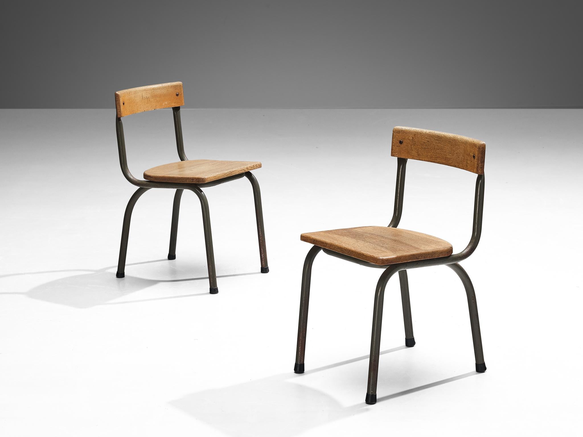 Willy Van Der Meeren for Tubax, chairs, metal, oak, Belgium, 1957.

This pair of industrial chairs is designed by the Belgian designer Willy Van Der Meeren. These sober yet interesting and moody set of chairs features a seat- and backrest in oakwood