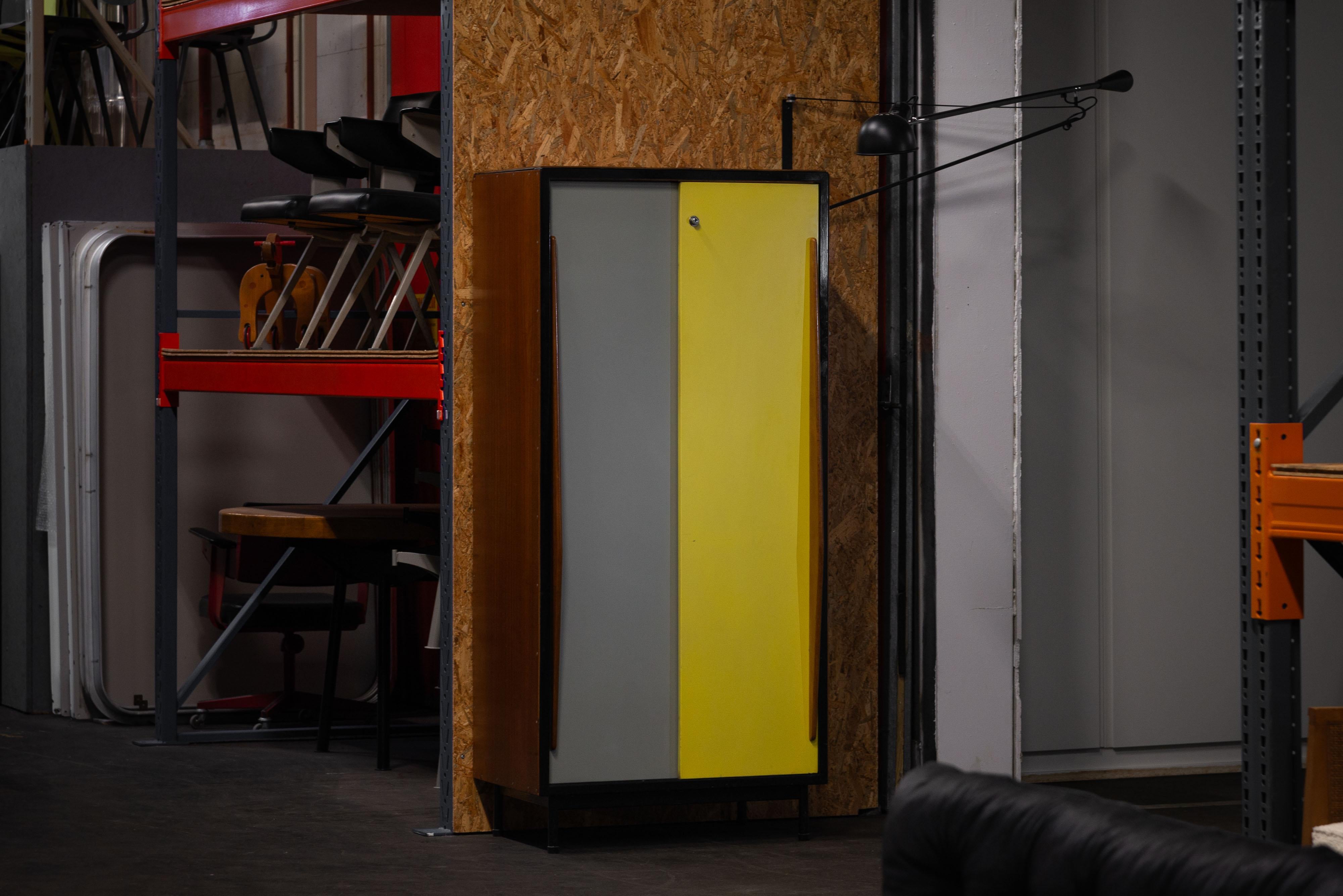 Industrial designed wardrobe by Willy van der Meeren and manufactured by Tubax, Belgium 1952. Originally it was used in boarding schools, so not many of them are still around. It's made of sturdy metal with teak side panels and has sliding doors –