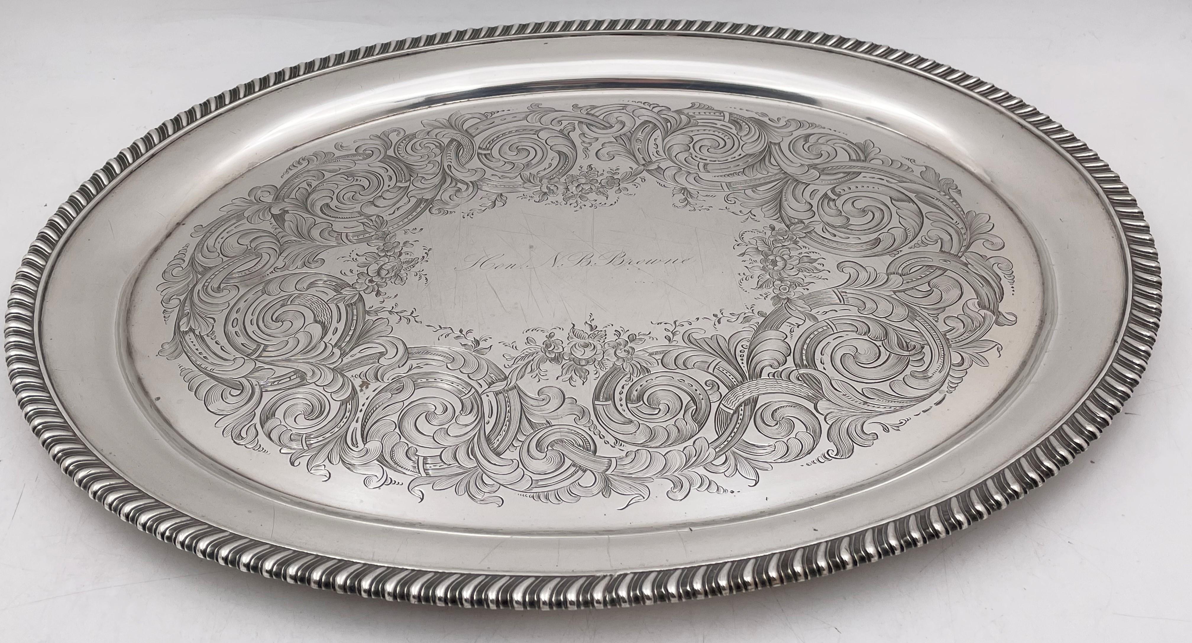 Robert and William Wilson, silver platter or tray, from the mid-19th century, with a gadrooned rim and exquisitely engraved foliate motifs. It measures 17 1/2'' in length by 13 1/4'' in width by 7/8'' in height, weighs 49.8 troy ounces and bears