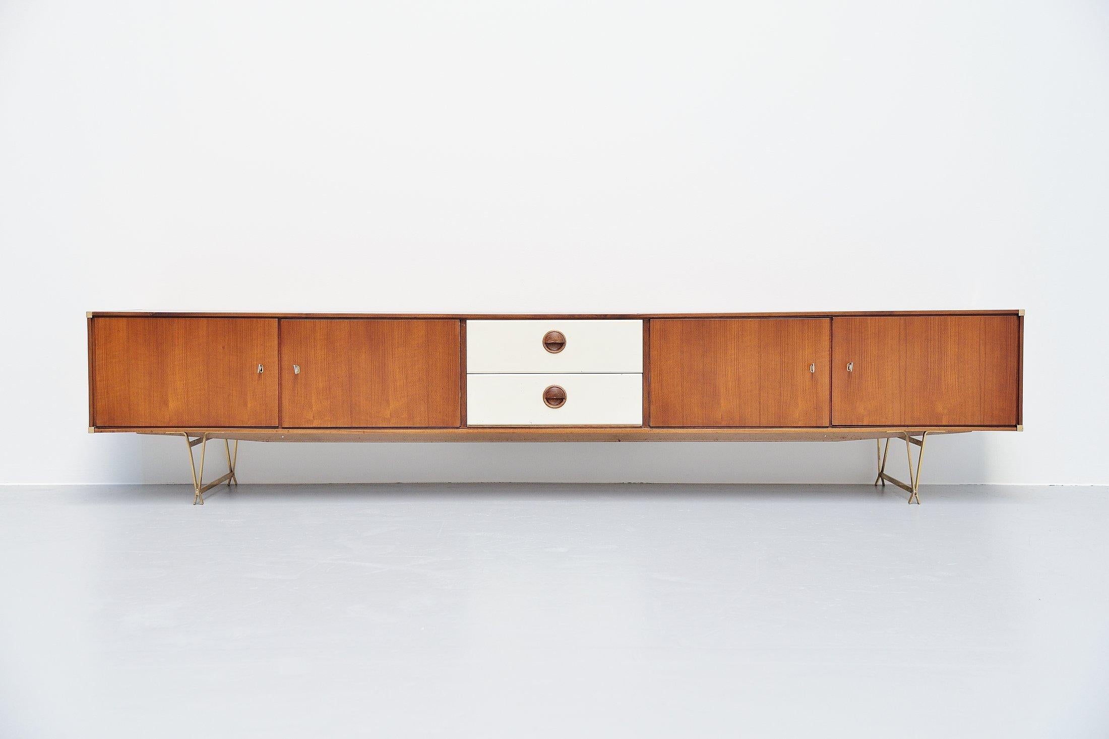 Ultra rare low sideboard designed by Wim Crouwel and manufactured by Fristho Franeker, Holland, 1954. This low sideboard has a fantastic modernist shape and typical Fristho details. The legs are in brass, the corners are made of solid brass as well.