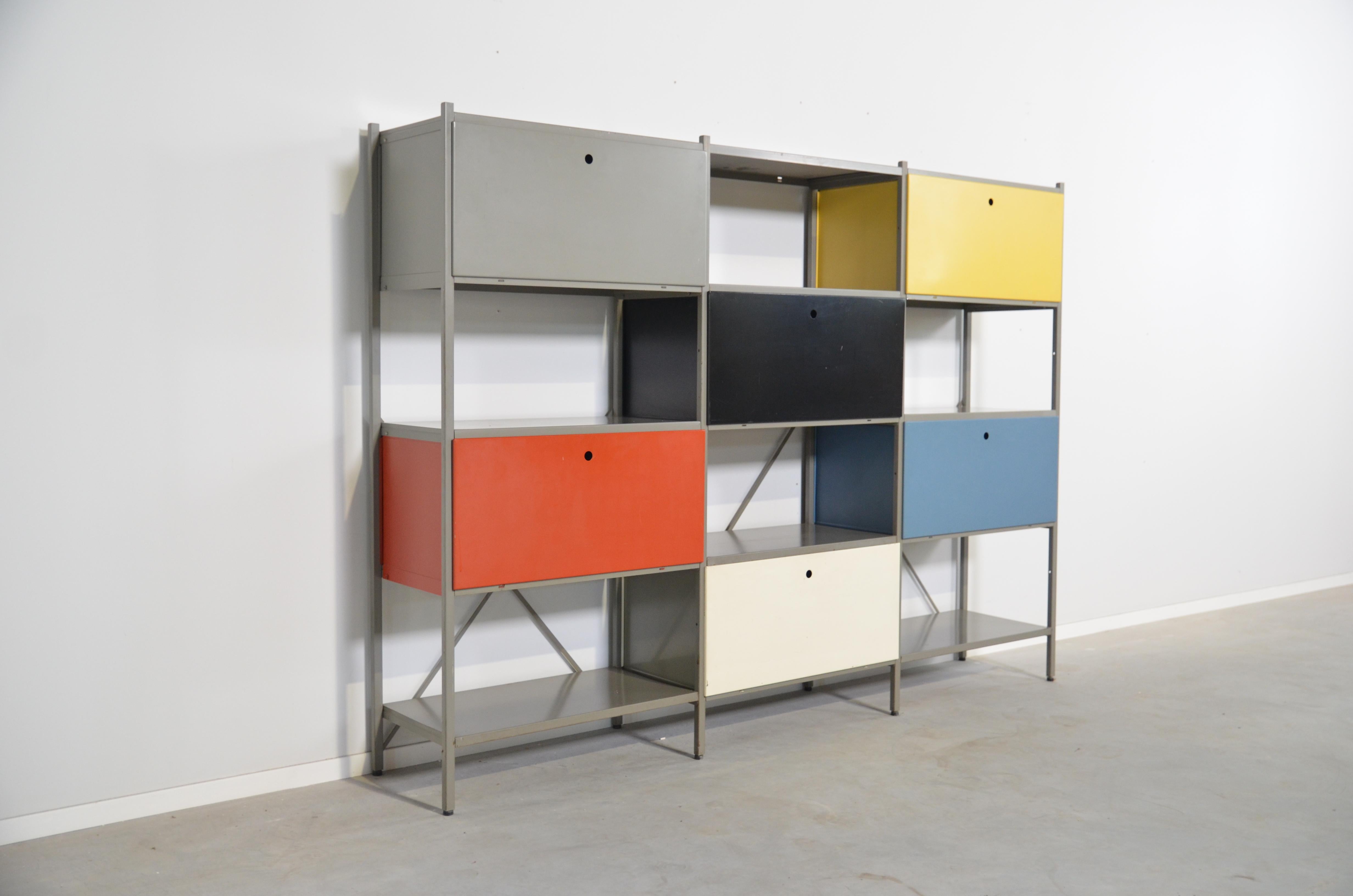 Industrial modulair wall system by Wim Rietveld for Gispen. This exemplar comes in a perfect combination of six cabinets with different colored front doors (grey, red, white, black, yellow and blue) alternated with six open units. Can be used as a