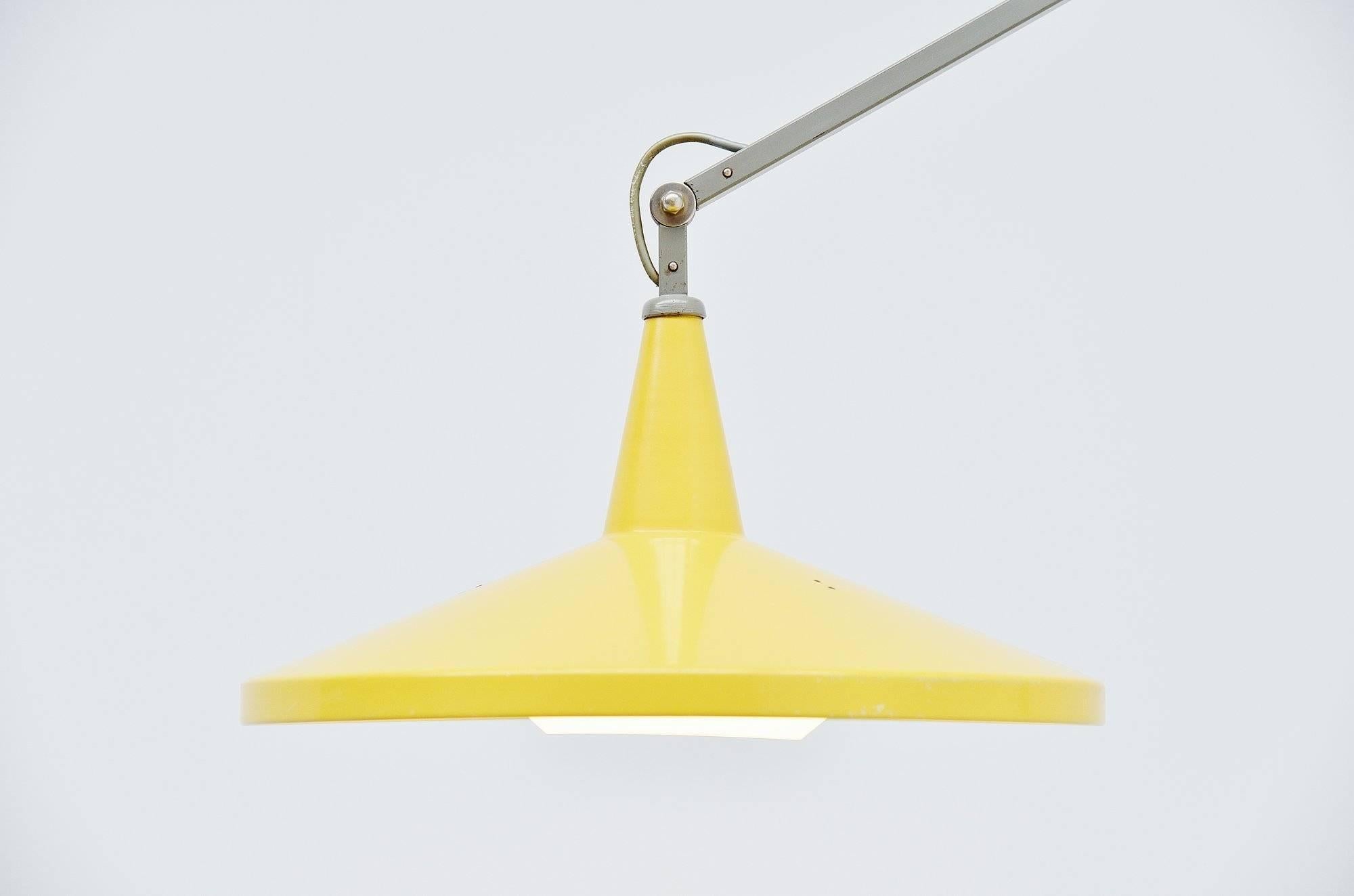 This is for a fantastic wall-mounted articulating lamp designed by Wim Rietveld, son of Gerrit Rietveld for Gispen in 1955. The lamp is mod no. 4050 and it has a very nice and original yellow, typical Gispen shade. The lamp comes with the original