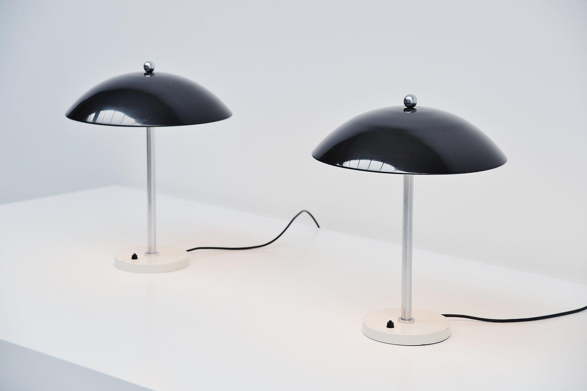 Very nice mushroom shaped table lamp pair model 5015 designed by Wim Rietveld and manufactured by Gispen Culemborg, Holland 1950. These lamps have a round weighted base, white lacquered with a brushed steel bar, use 2 E27 bulbs up to 60 watt each