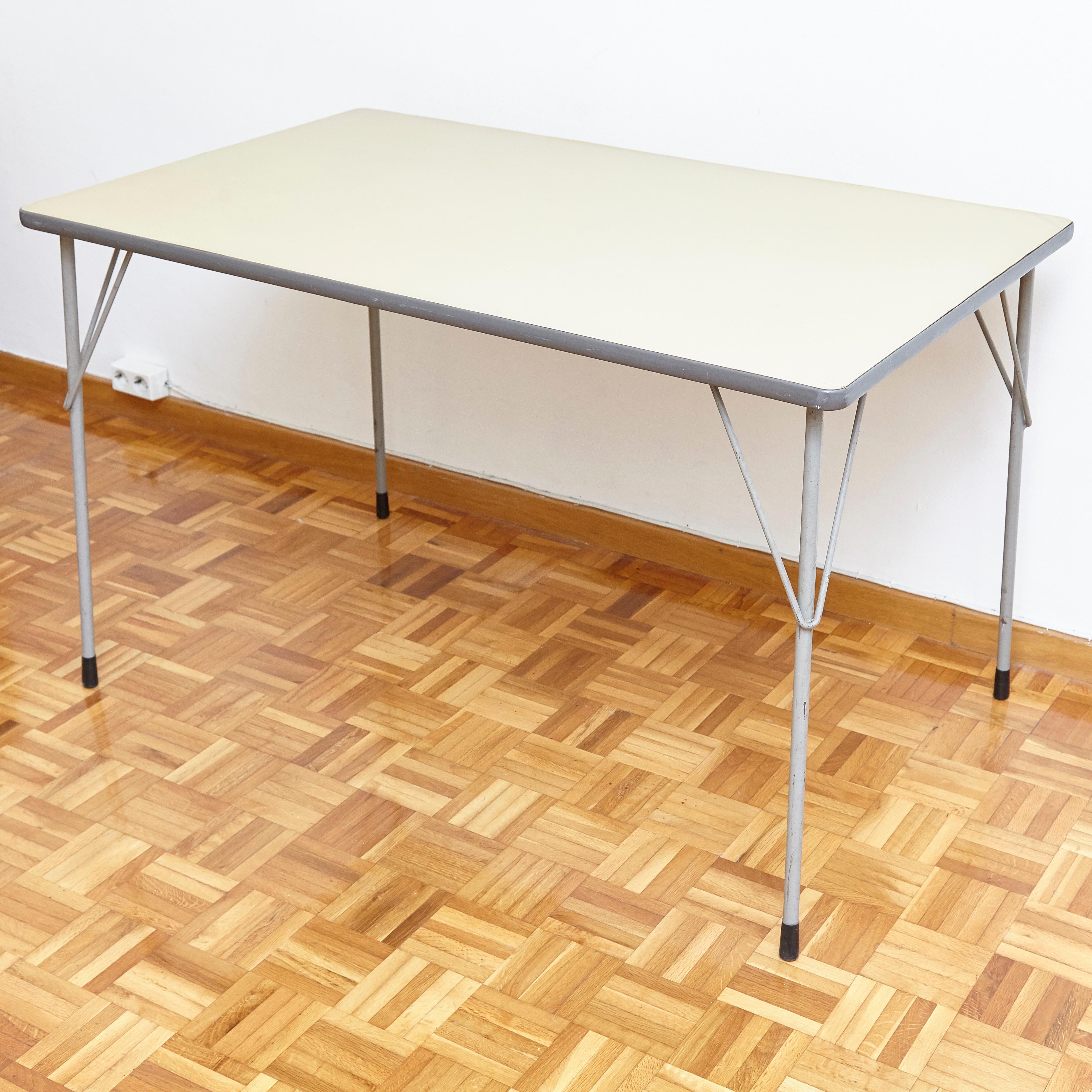 This table was designed by Wim Rietveld and manufactured by Ahrend de Cirkel in the Netherlands in, circa 1960. 
The table has a steel frame. 
It remains in a good vintage condition, with wear consistent with age and use.