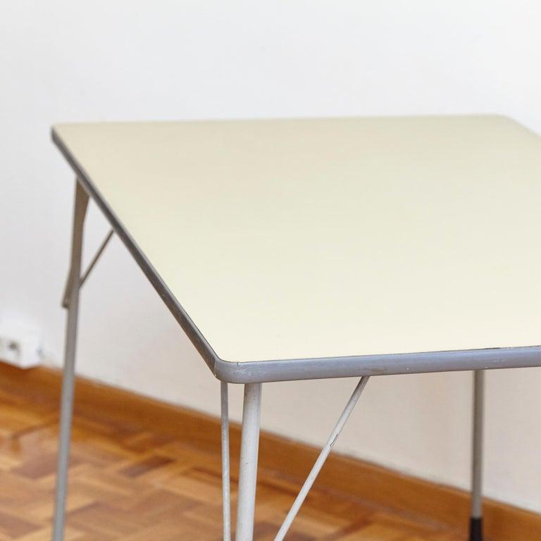 This table was designed by Wim Rietveld and manufactured by Ahrend de Cirkel in the Netherlands in, circa 1960. 
The table has a steel frame. 
It remains in a good vintage condition, with wear consistent with age and use.