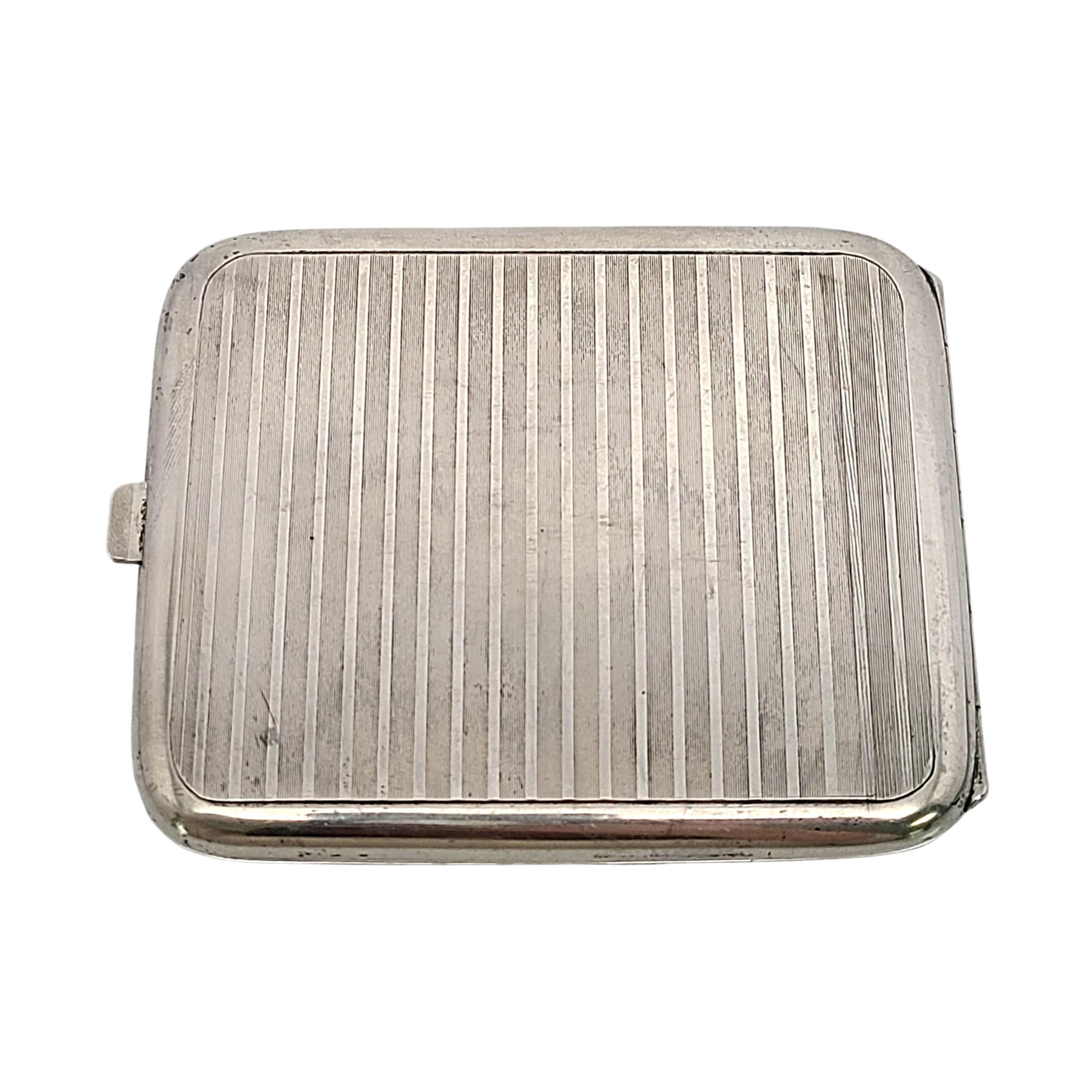 Vintage German 900 silver cigarette case by Wimmer & Rieth, with monogram.

Monogram appears to be WBS (inside the case)

Engine turned etched stripe sterling silver cigarette case with scroll design frame on the front. Gold wash interior. Case is