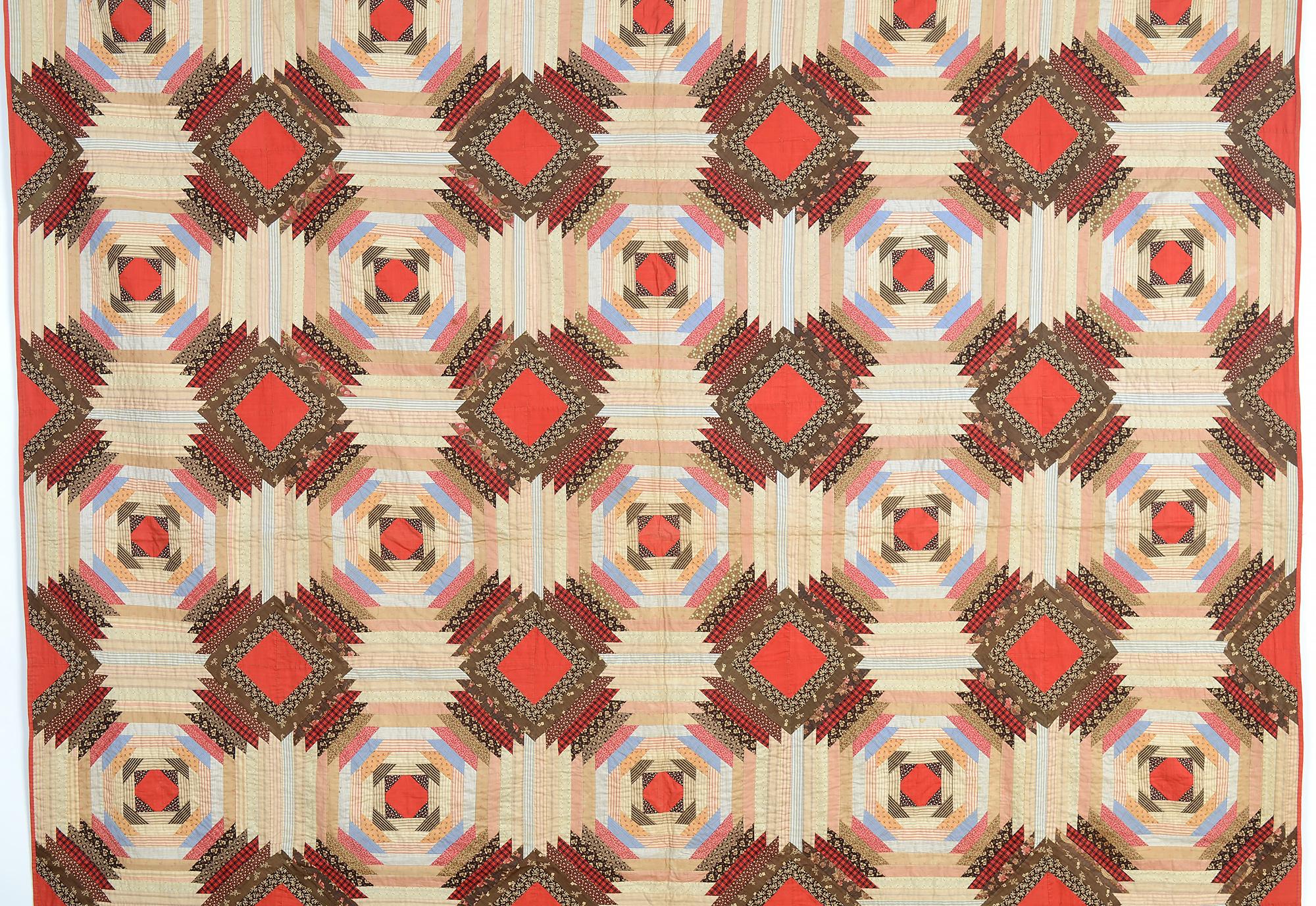 The Windmill Blades (aka Pineapple Log Cabin) quilt is always a design with lots of strong movement. In this example, the solid red centers effectively play off against the remaining printed fabrics. The use of dark prints around the red centers of