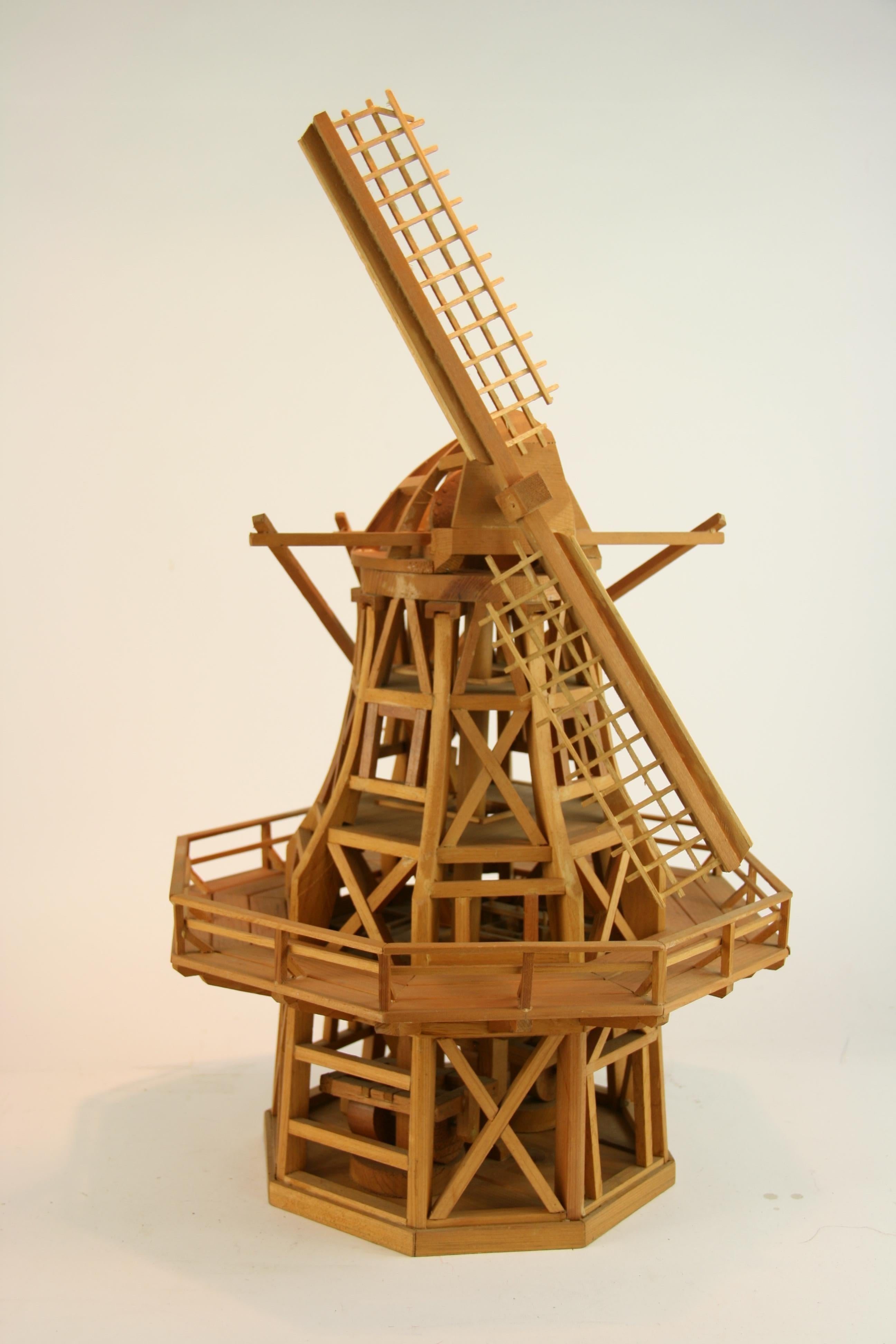 3-449 hand crafted wood architectural model of a windmill.
Detail of grinding stone on lower level and stairs to each level.
Missing 2 of the spoke for the sails and back rail
Measures: Height to top of tower 17'
Height to top of sail 28