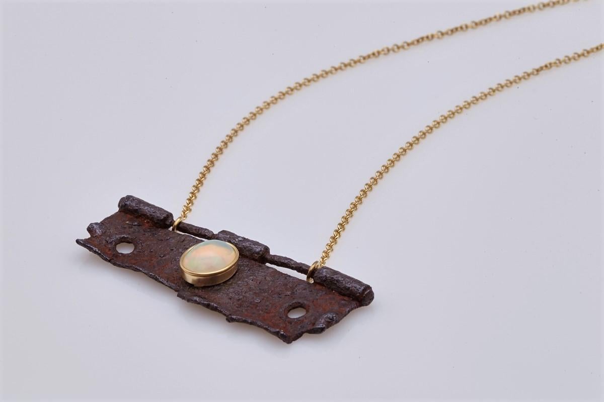 A really unique necklace with excepitonal work. Made of founded rusty object with opale stone and 9Kt yellow gold, totally handmade. 
A piece of jewelry with lots of inspiration, that will attract all the eyes on you.
This Art necklace is definitely