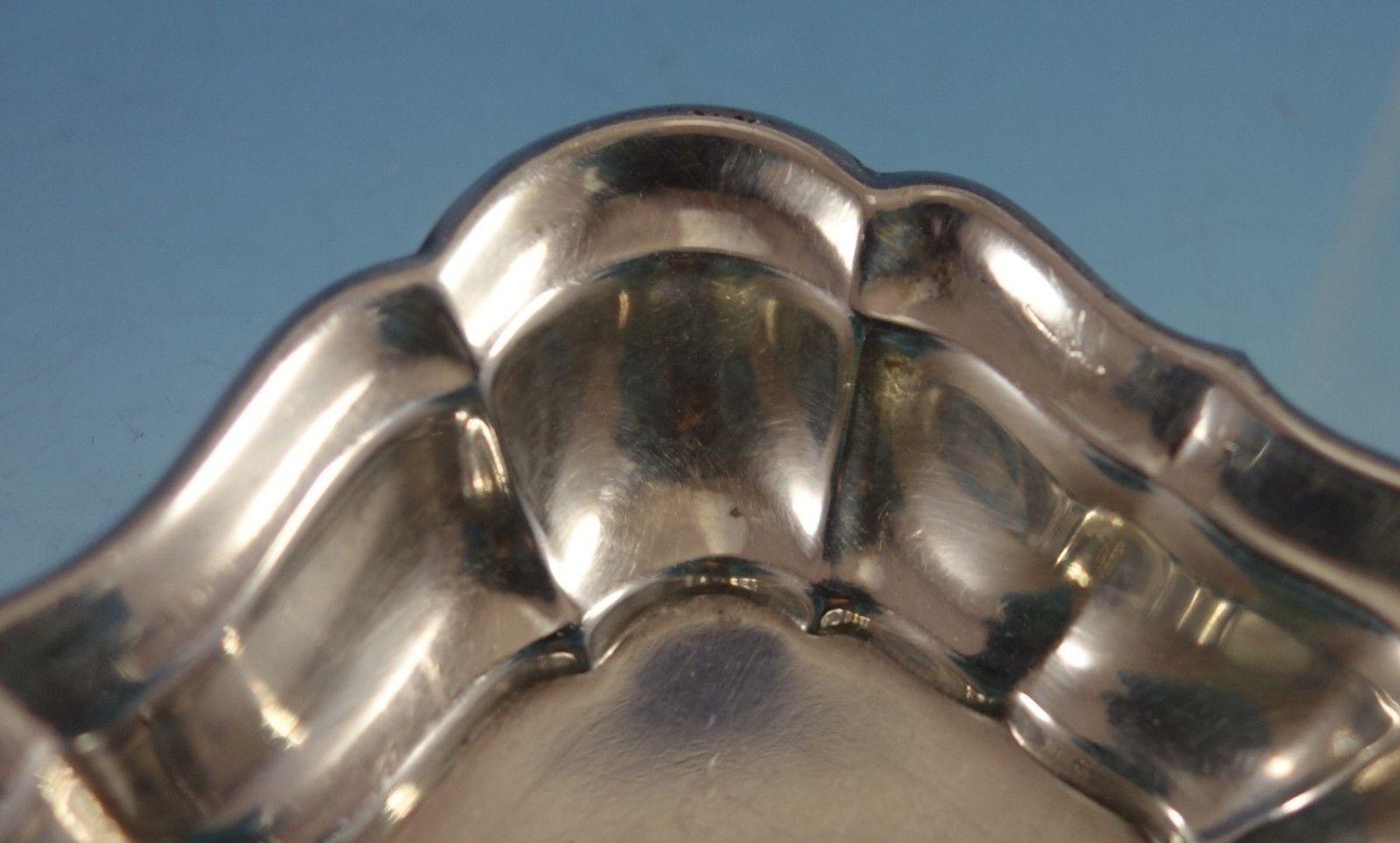 Windsor by Reed & Barton 
Windsor by Reed & Barton sterling silver nut cup. It is marked with #X958A. The cup measures 1/2 x 2 7/8 x 2 1/8 and weighs 0.6 ozt. It is not monogrammed and is in good vintage condition with a few small dings. 


 