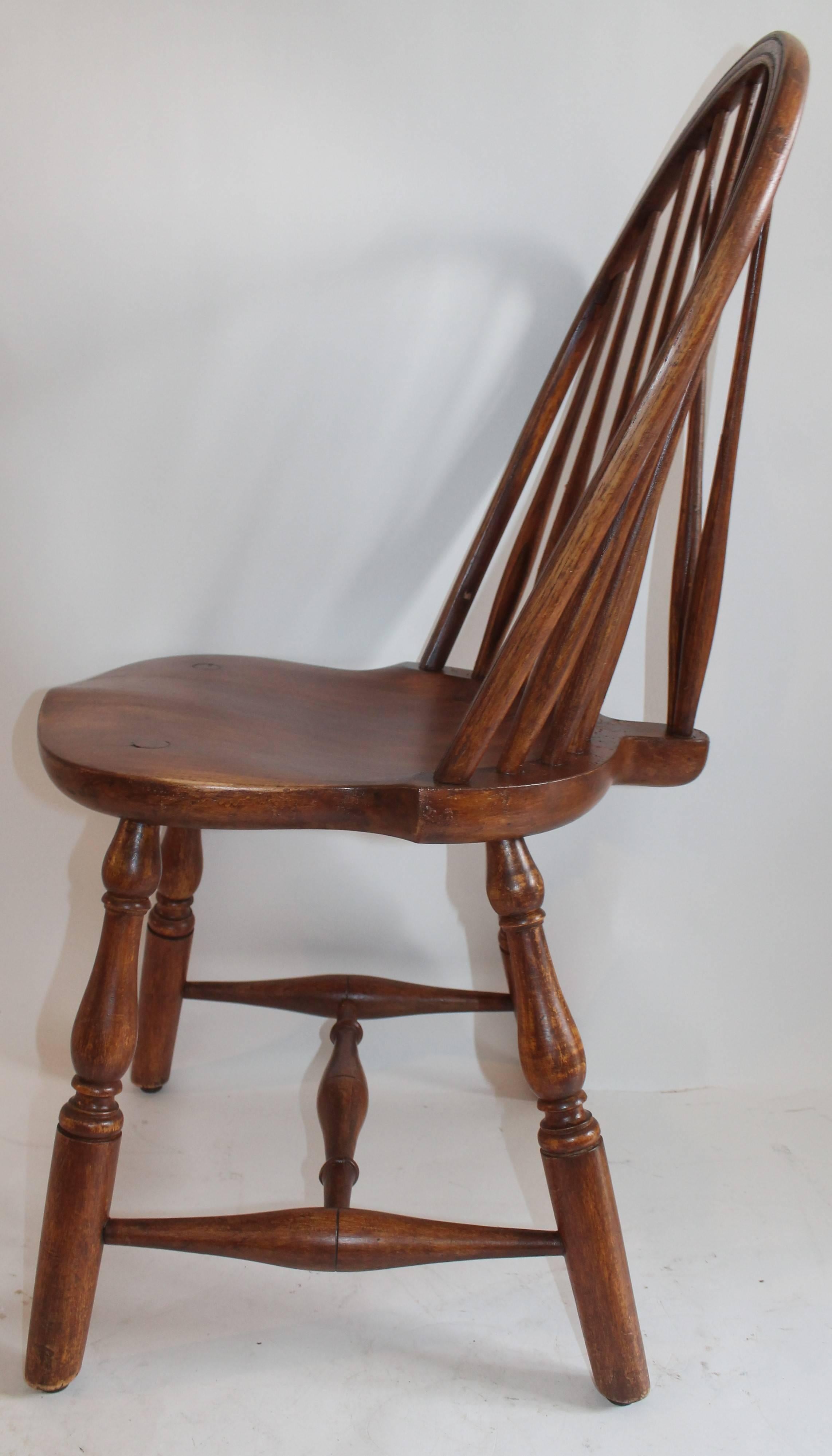 This fine example is a 20th century version of a 18th century brace back windsor chair. It is signed on the base The Marble & Shattuck Chair Co. The condition is very good and sturdy. This chair is made of maple.