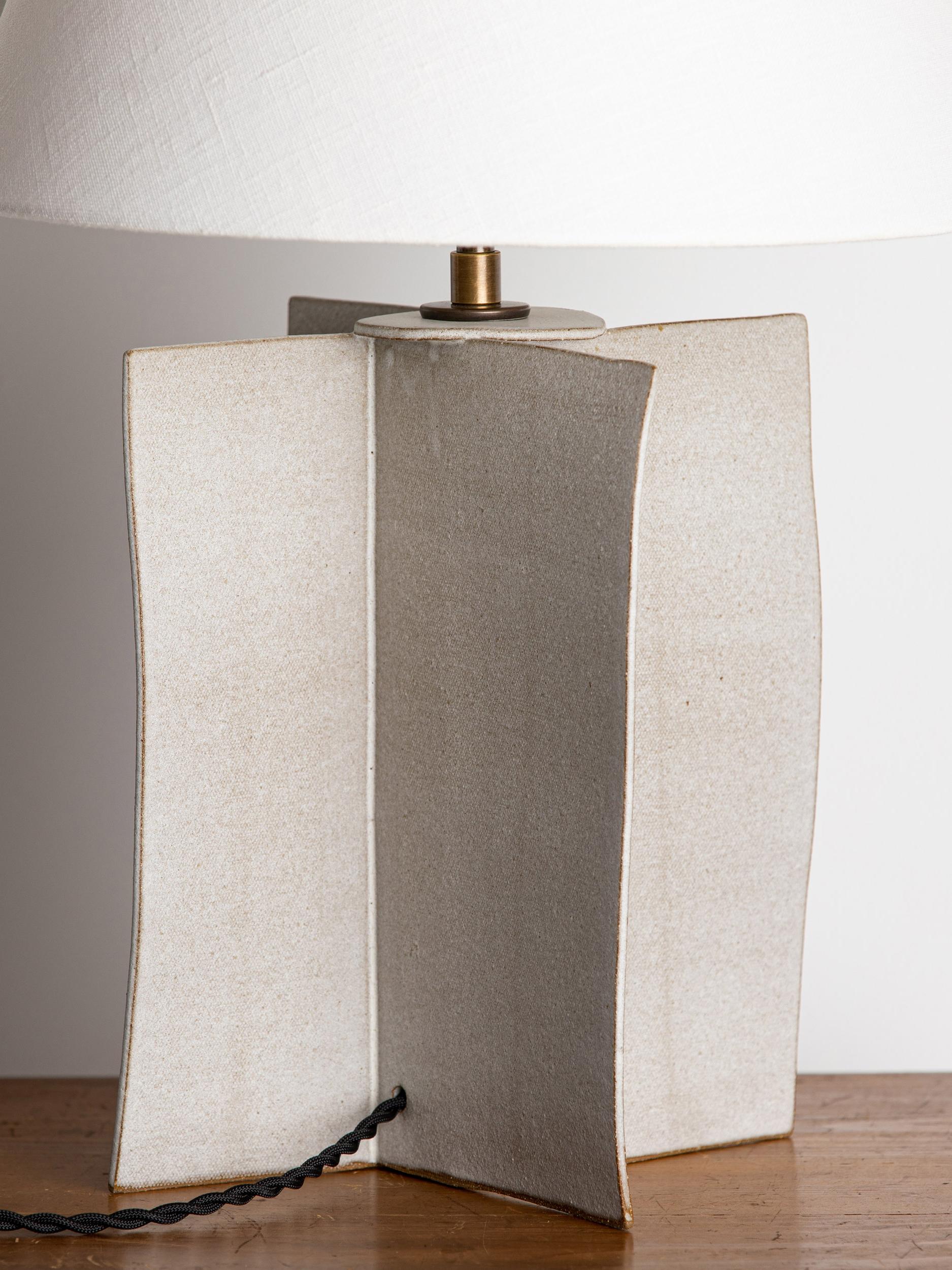Our stoneware Windsor Lamp is handcrafted using slab-construction techniques.

FINISH

- Dipped glaze, pictured in parchment 
- Antique brass fittings
- Twisted black-cloth cord
- Full-range dimmer socket
- Paper or linen