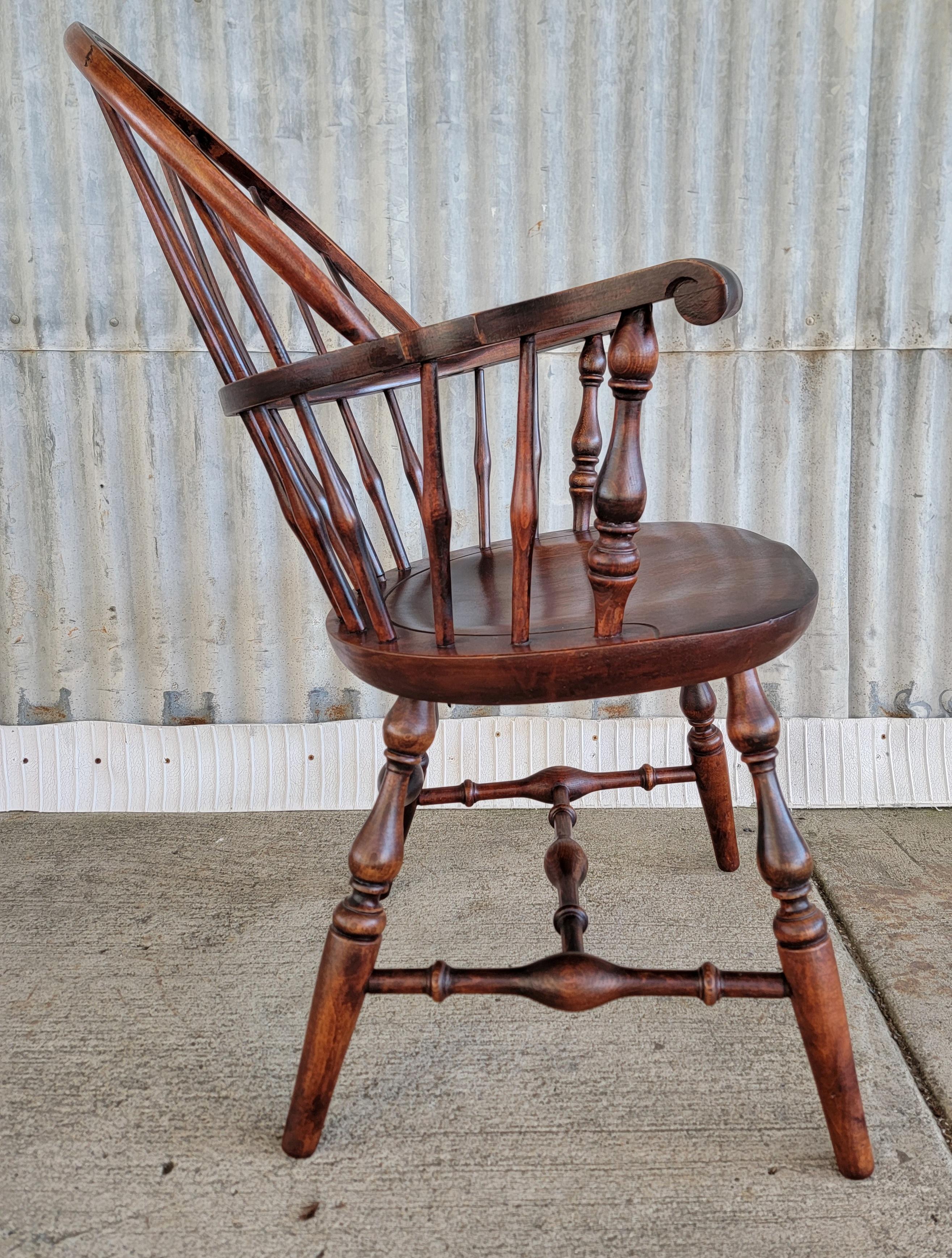 A Windsor style armchair quality crafted by Nichols & Stone of Gardner, Mass., circa. 1950's. Structurally very solid, older refinish. Makers brand under seat.