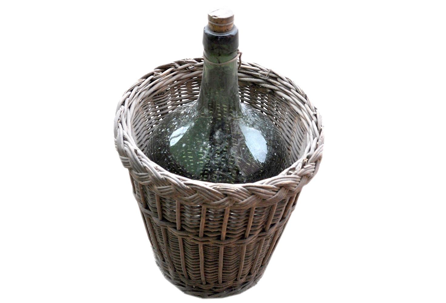 A vintage wine bottle and carrier found in Hungary. Basket and bottle is original, found as is. This truly is a wonderful find and has had lots of use - a treasure with memories.